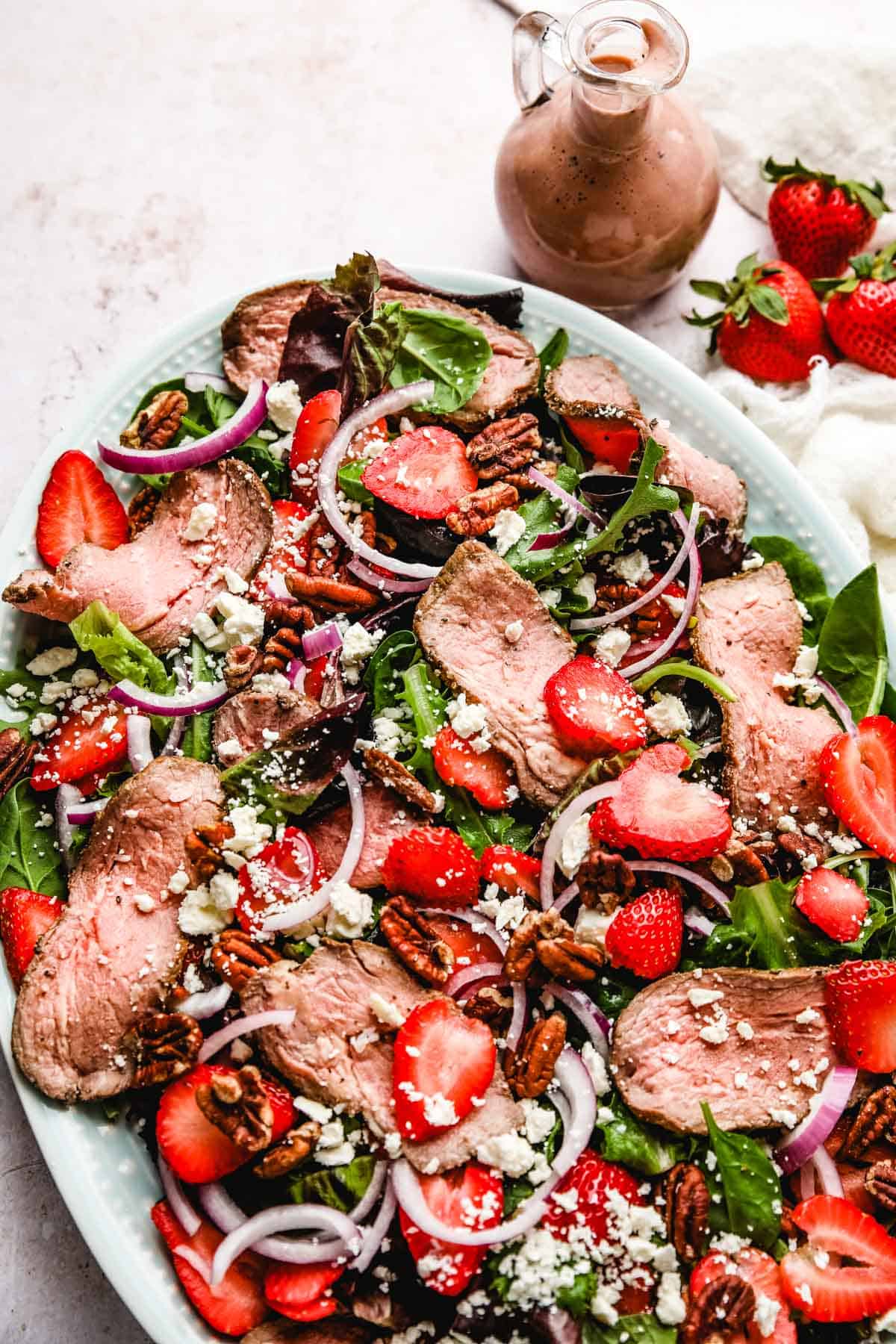 strawberry salad with steak, onions, feta, and balsamic dressing