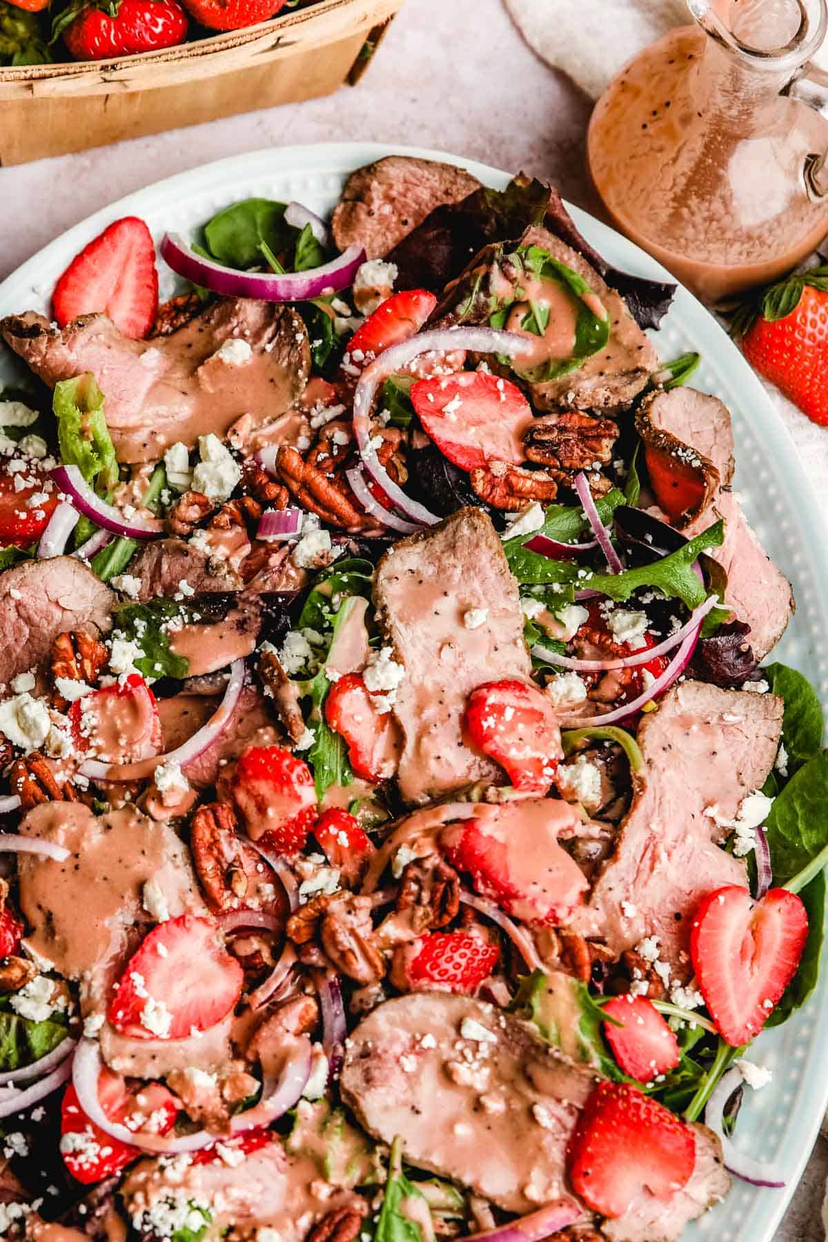a close up shot of the steak strawberry salad with poppy seed dressing