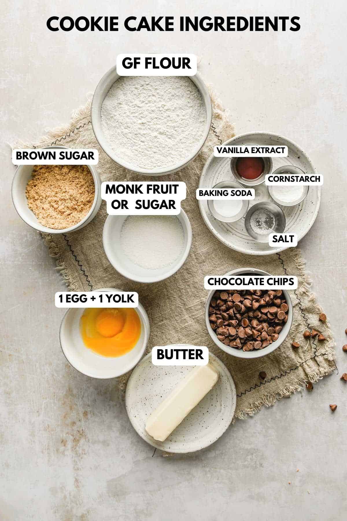 a photo of cookie cake ingredients in nesting bowls labeled