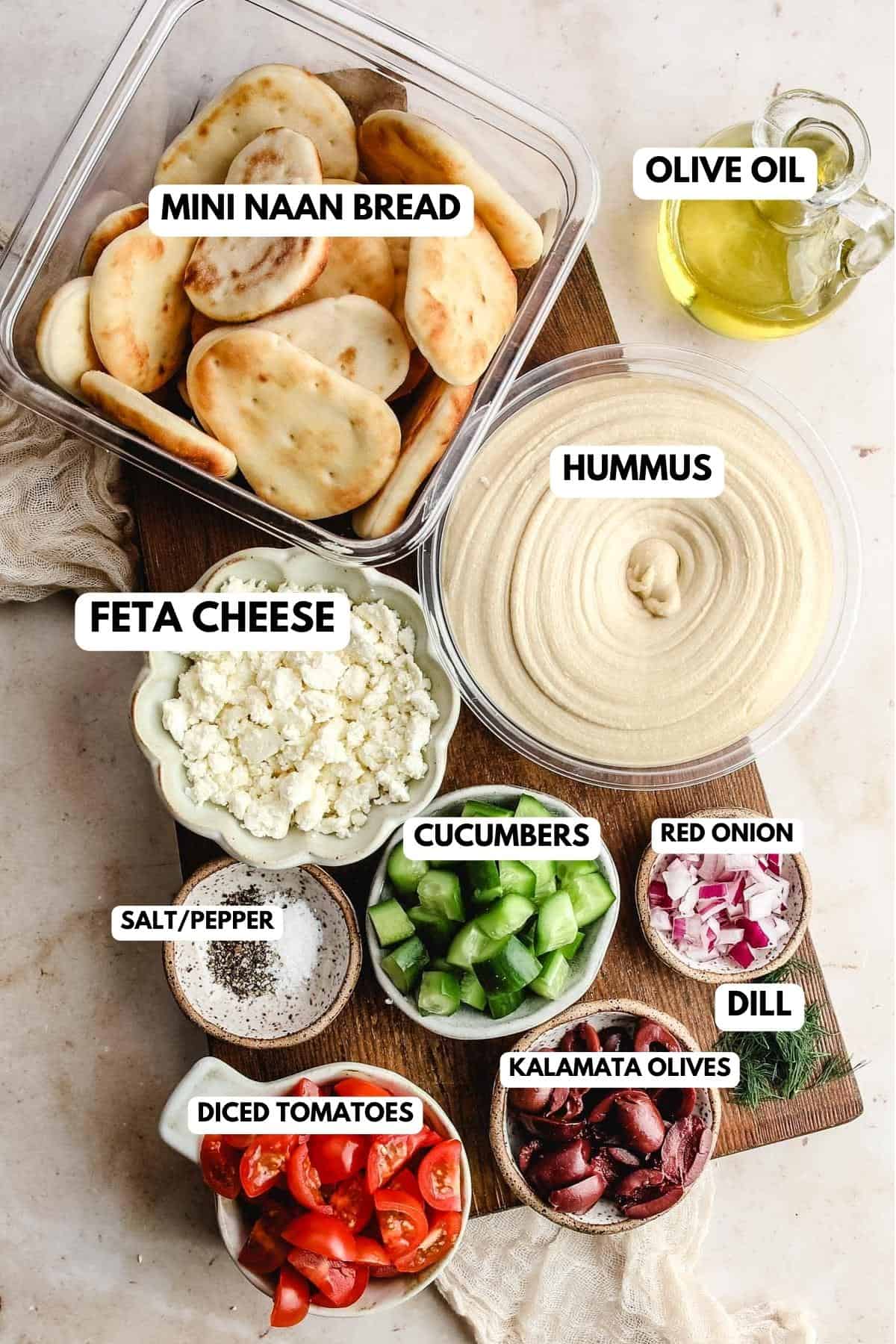 recipe ingredients for pita and hummus butter board in nesting bowls and labeled. 