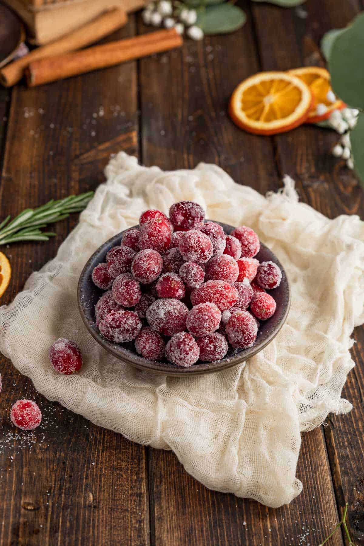 a bowl of candied cranberries resting atop a cheese cloth