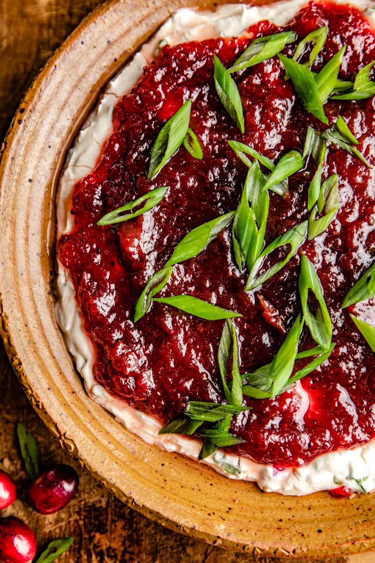 an overhead shot of cranberry jalapeno dip topped with green onions