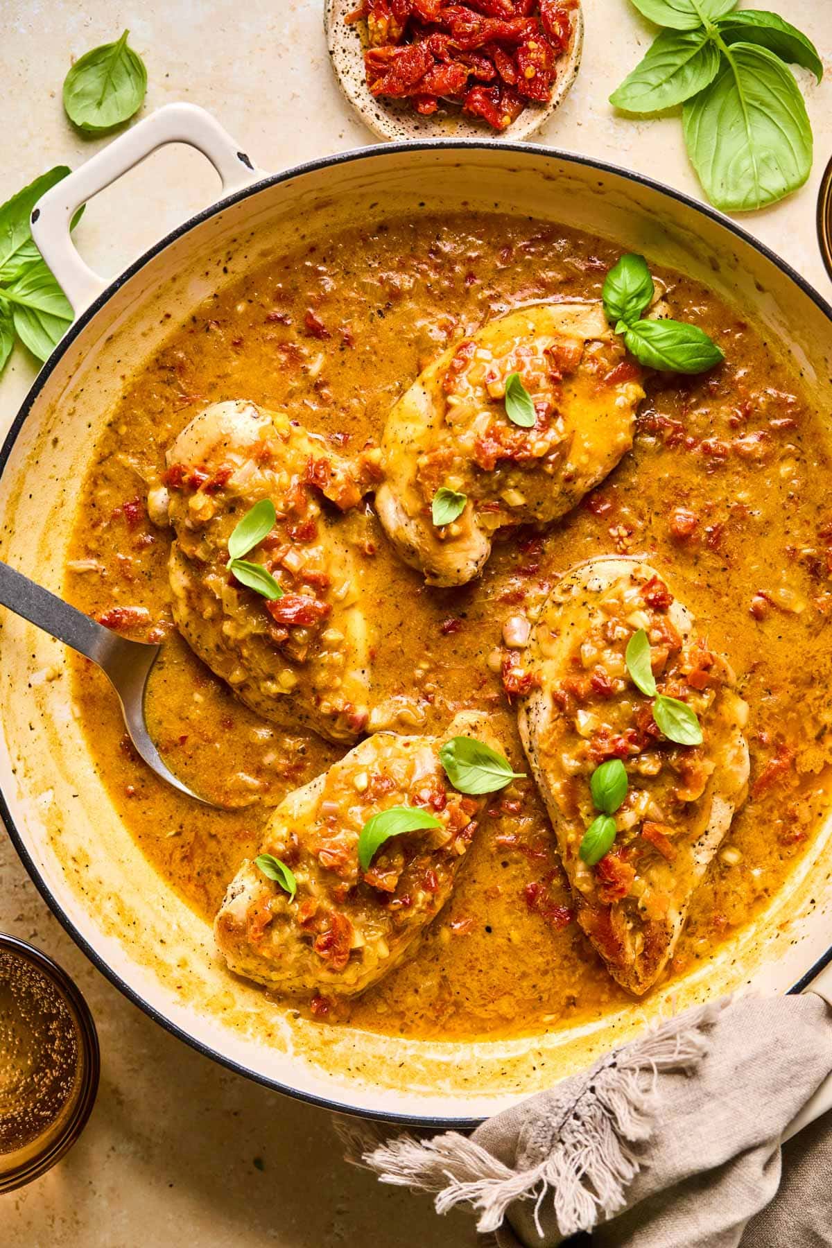 a skillet filled with chicken and cream sauce