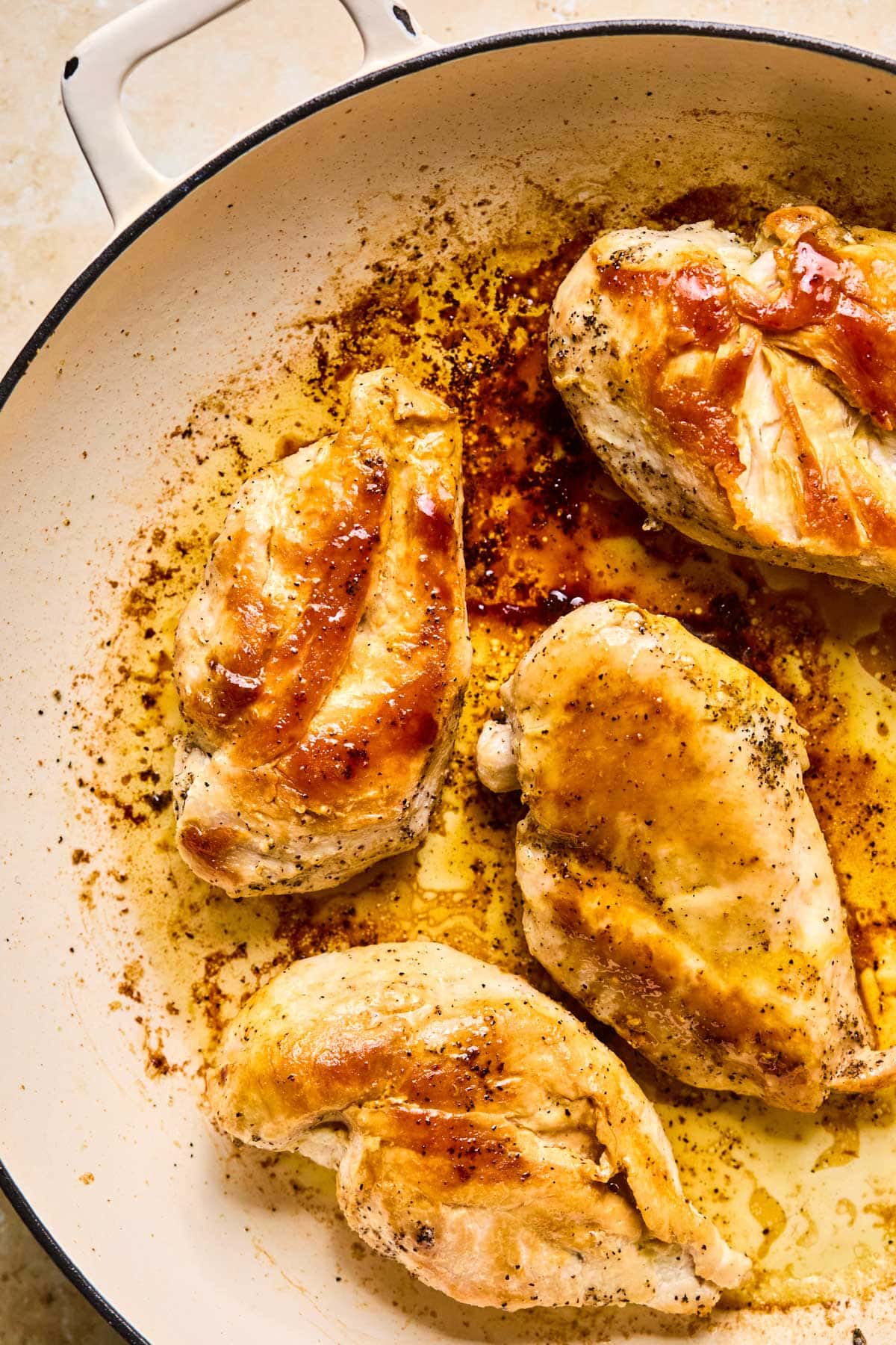 cooked chicken in a pan with golden brown skin 