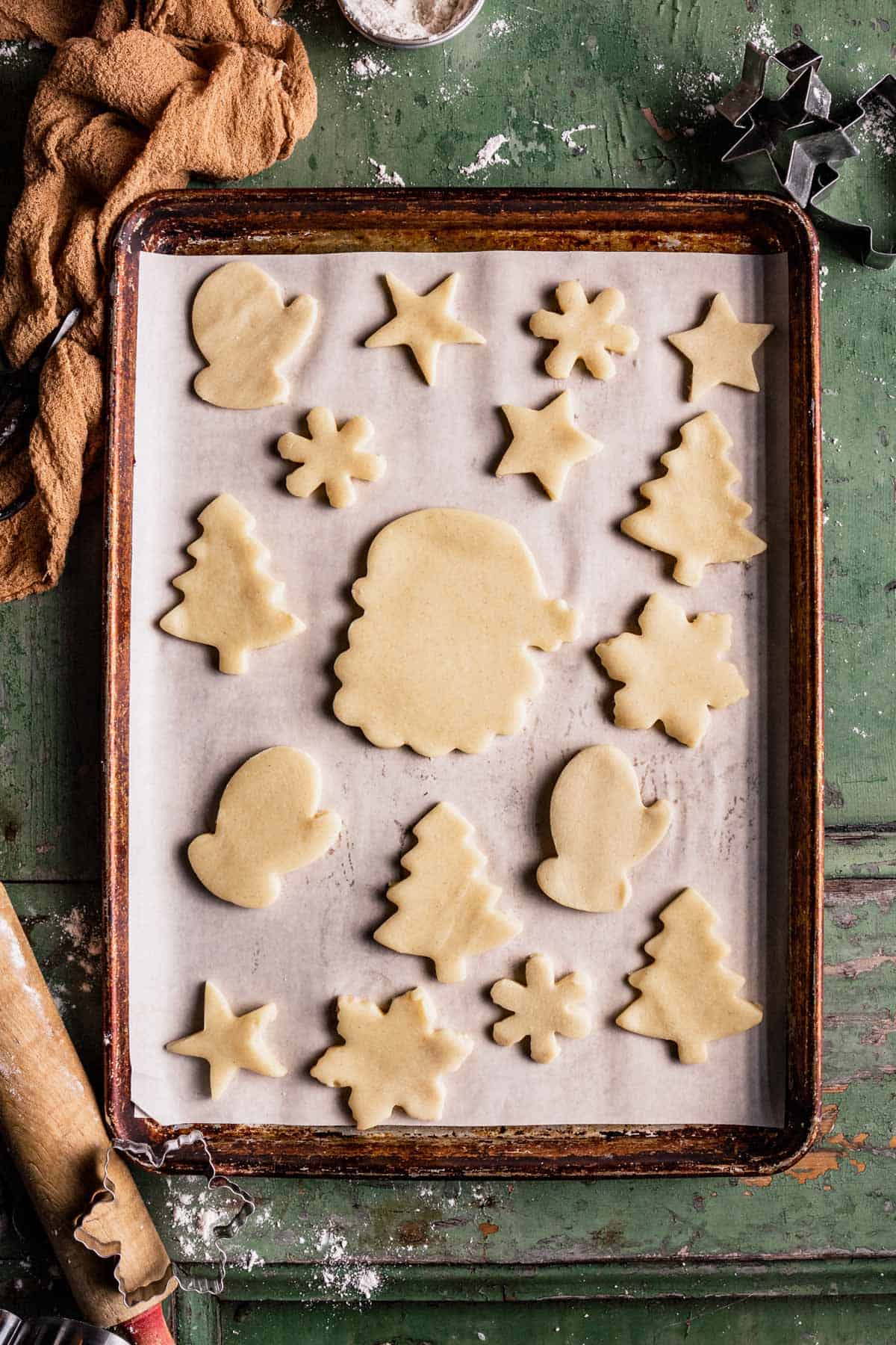 Gluten-Free Sugar Cookies on a sheet in different Christmas shapes