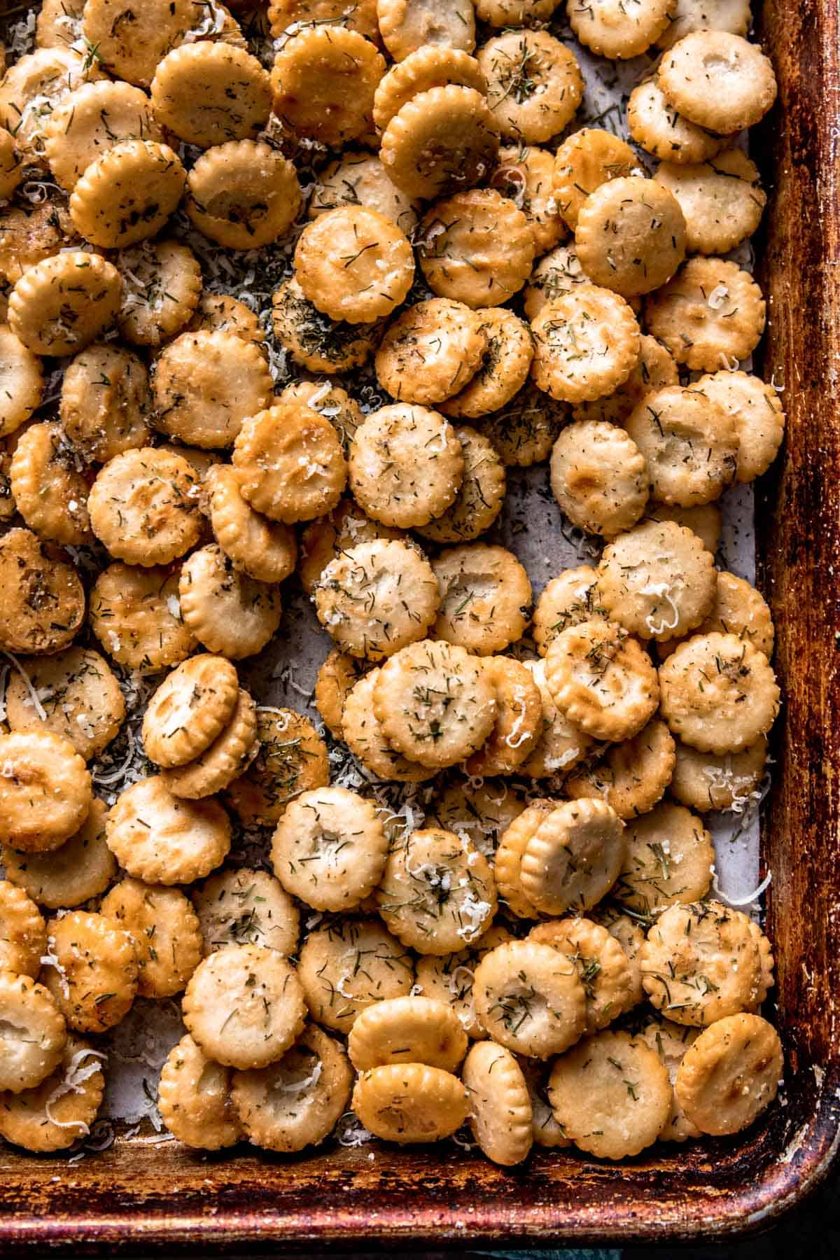 seasoned oyster crackers on a lined baking sheet. 
