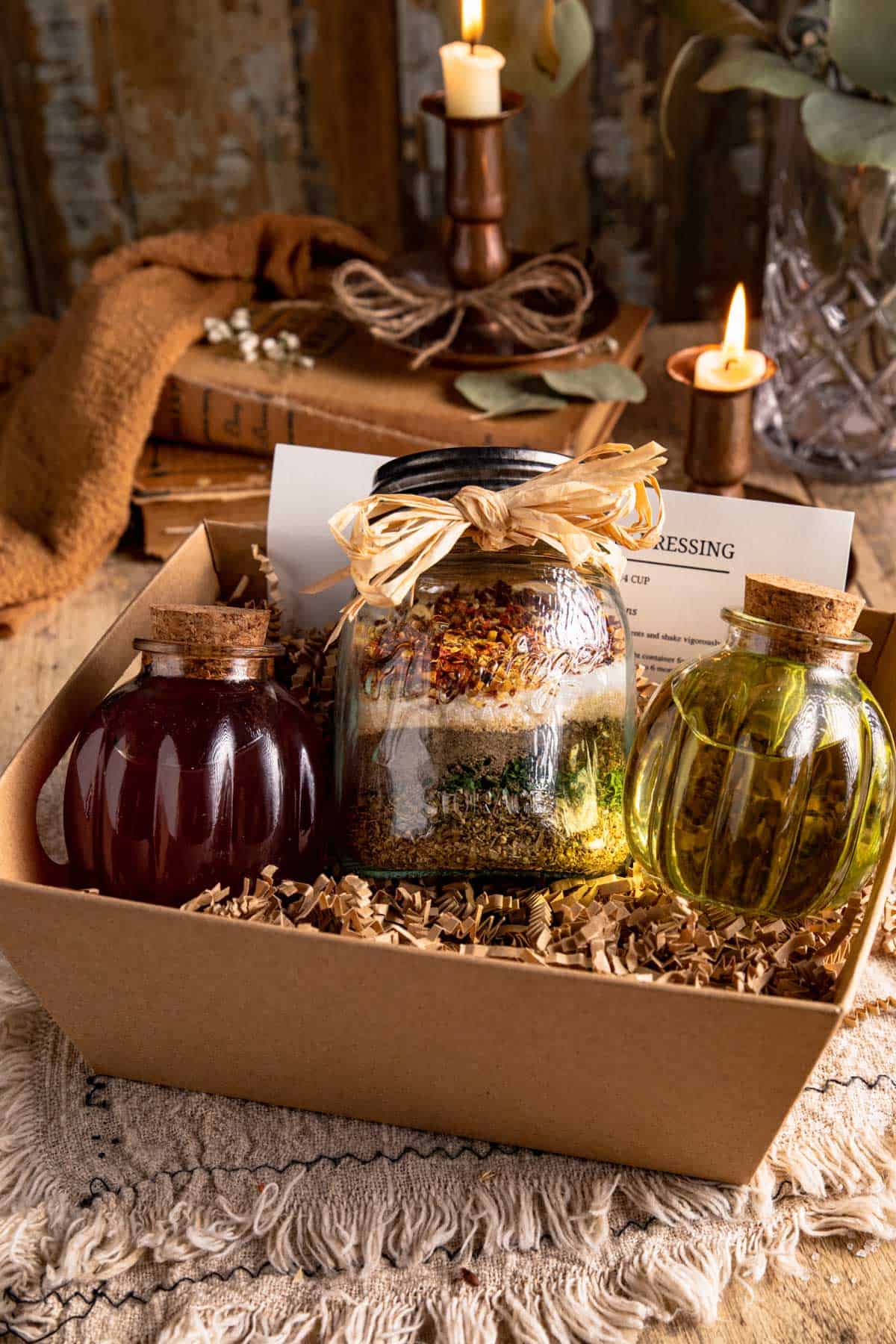 a gift box filled with zesty Italian seasoning, red wine vinegar, olive oil, and a recipe card. 