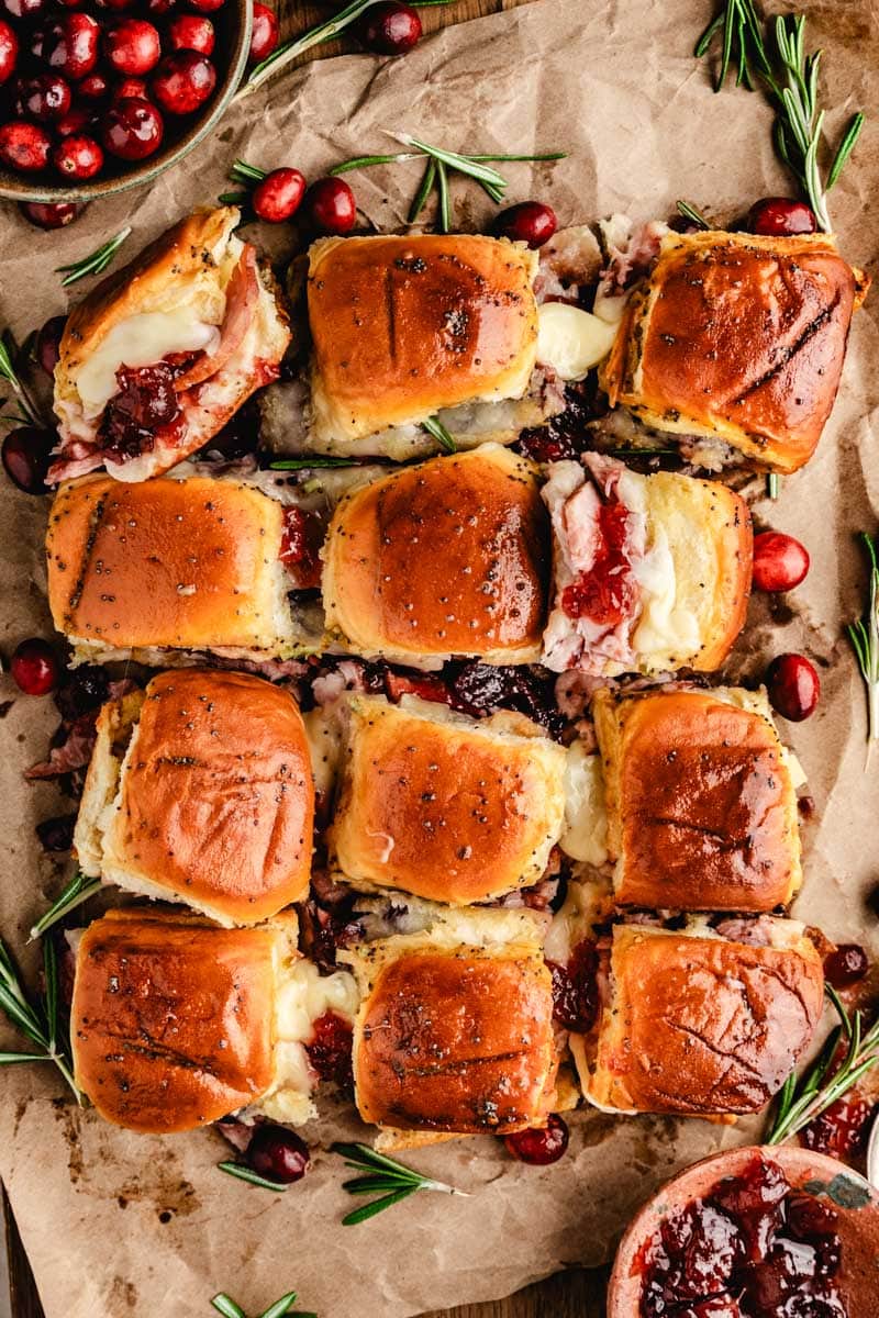 an overhead shot of small turkey and cranberry sliders in rows and columns
