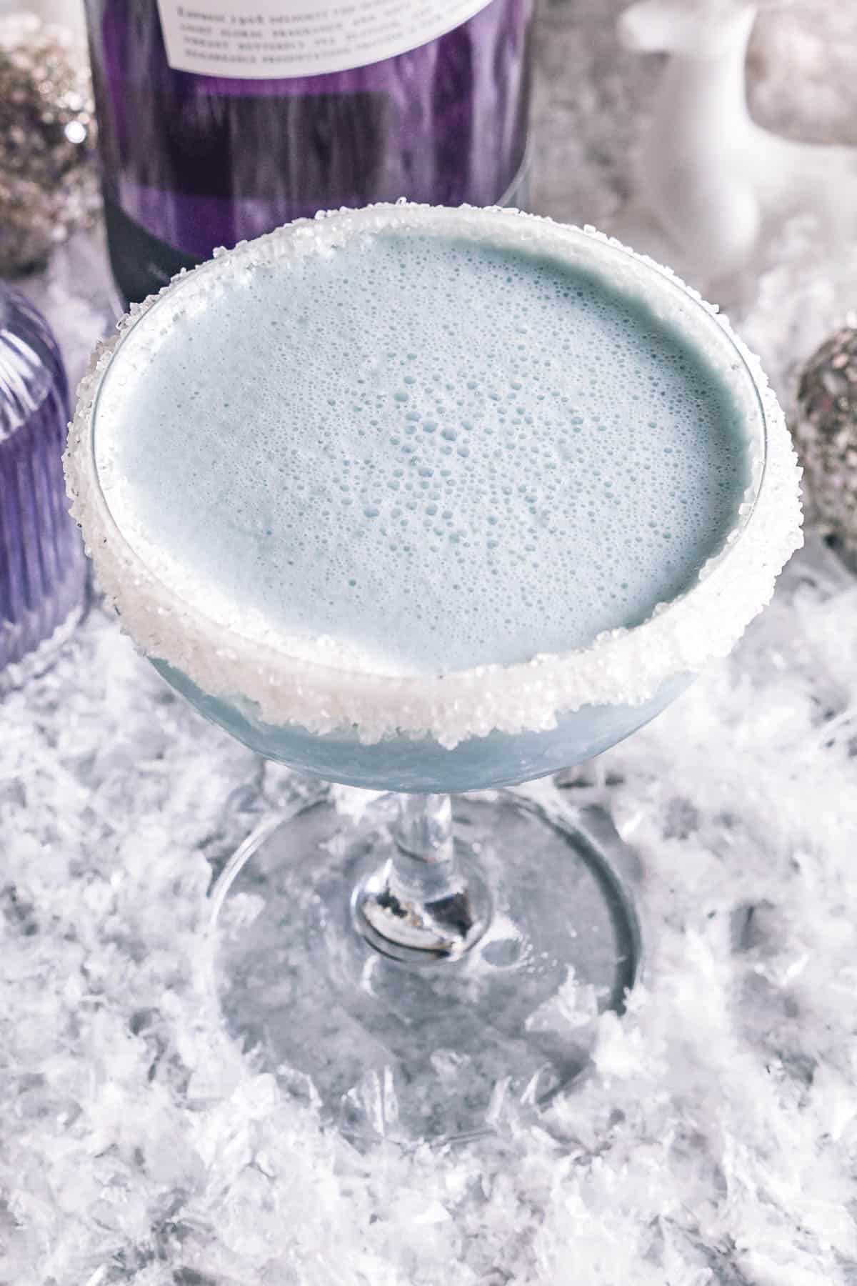 an overhead shot of a blue, frozen martini drink 