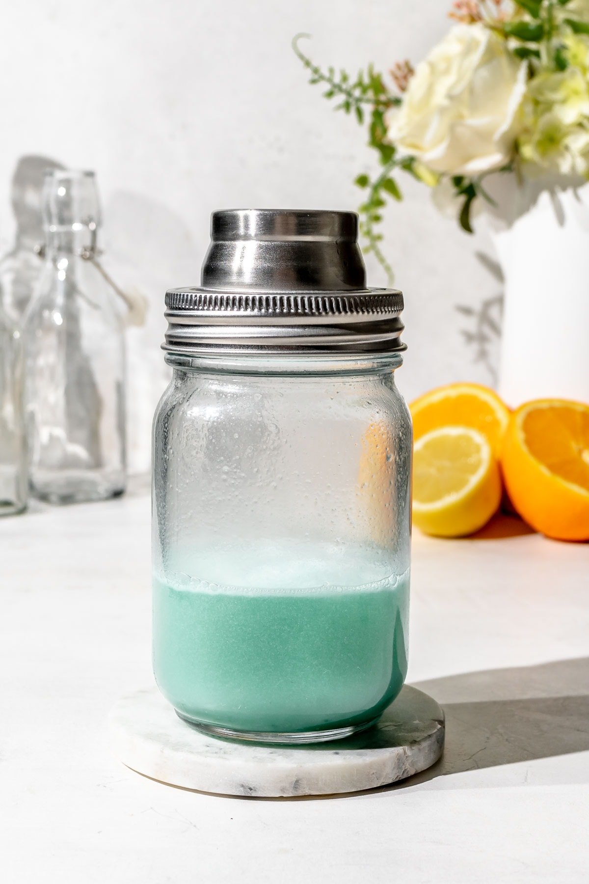 a cocktail shaker filled with blue liquid