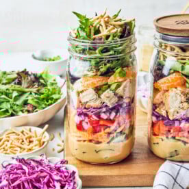a close up of an Asian chicken mason jar salad.