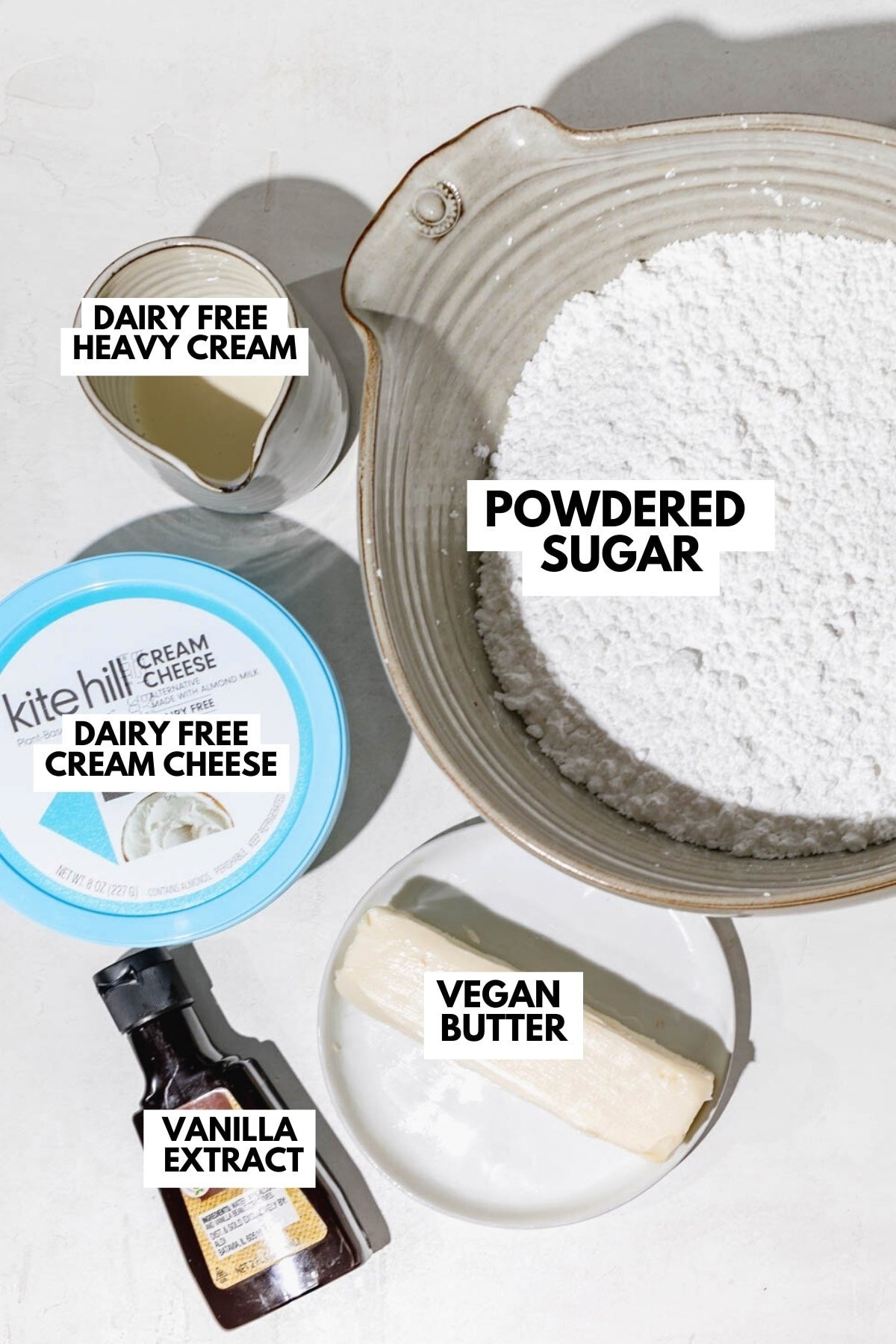 dairy free cream cheese frosting recipe ingredients in small bowls and labeled. 