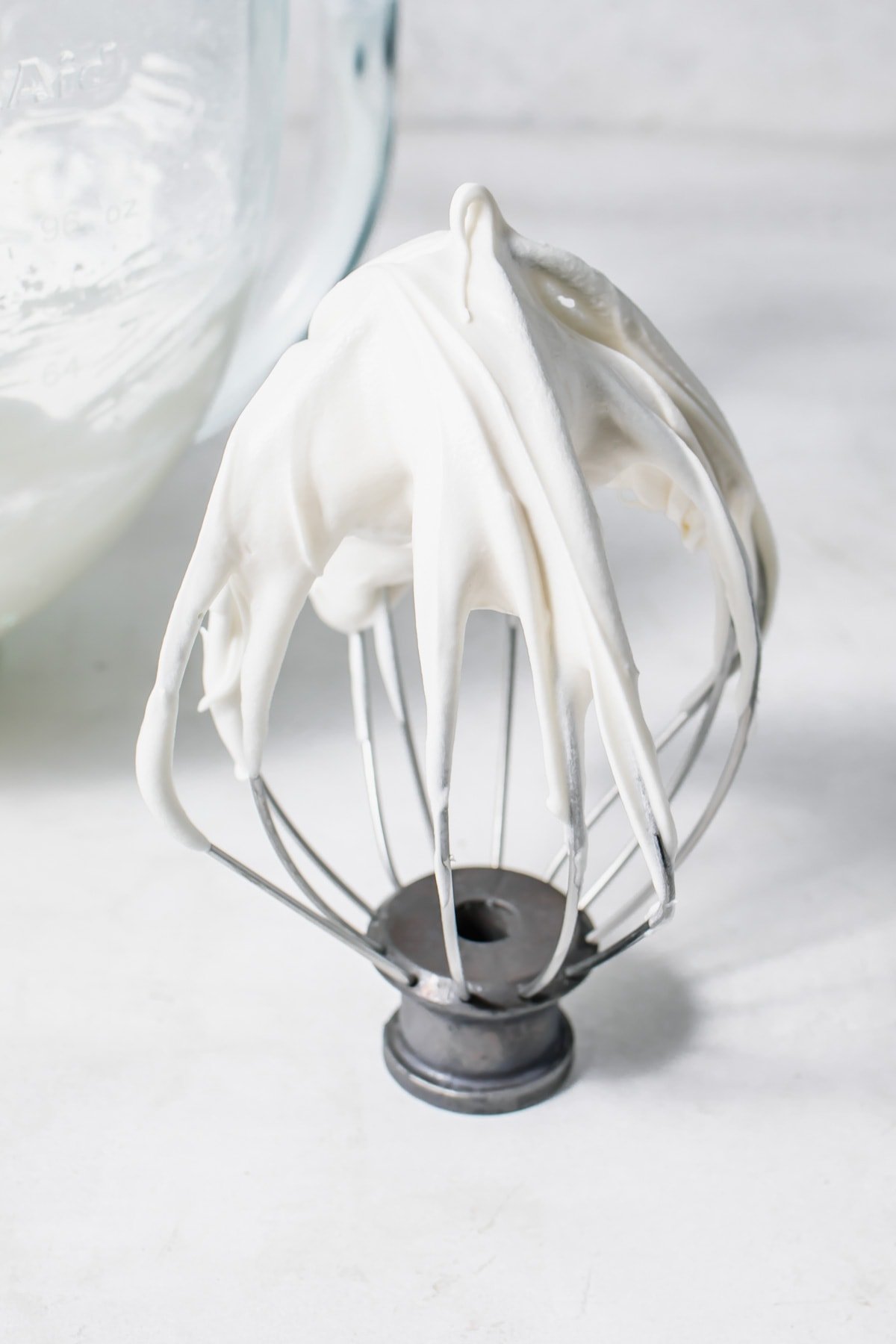 a whisk with cream cheese frosting