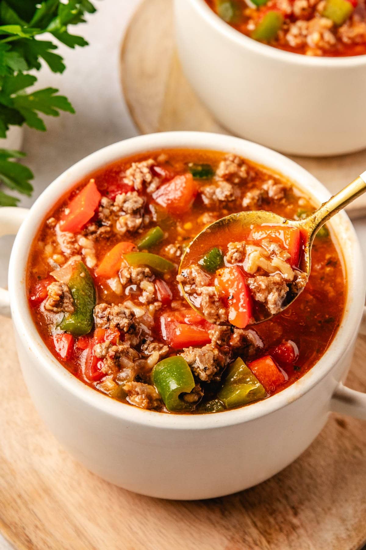 a small white bowl filled with crockpot stuffed pepper soup