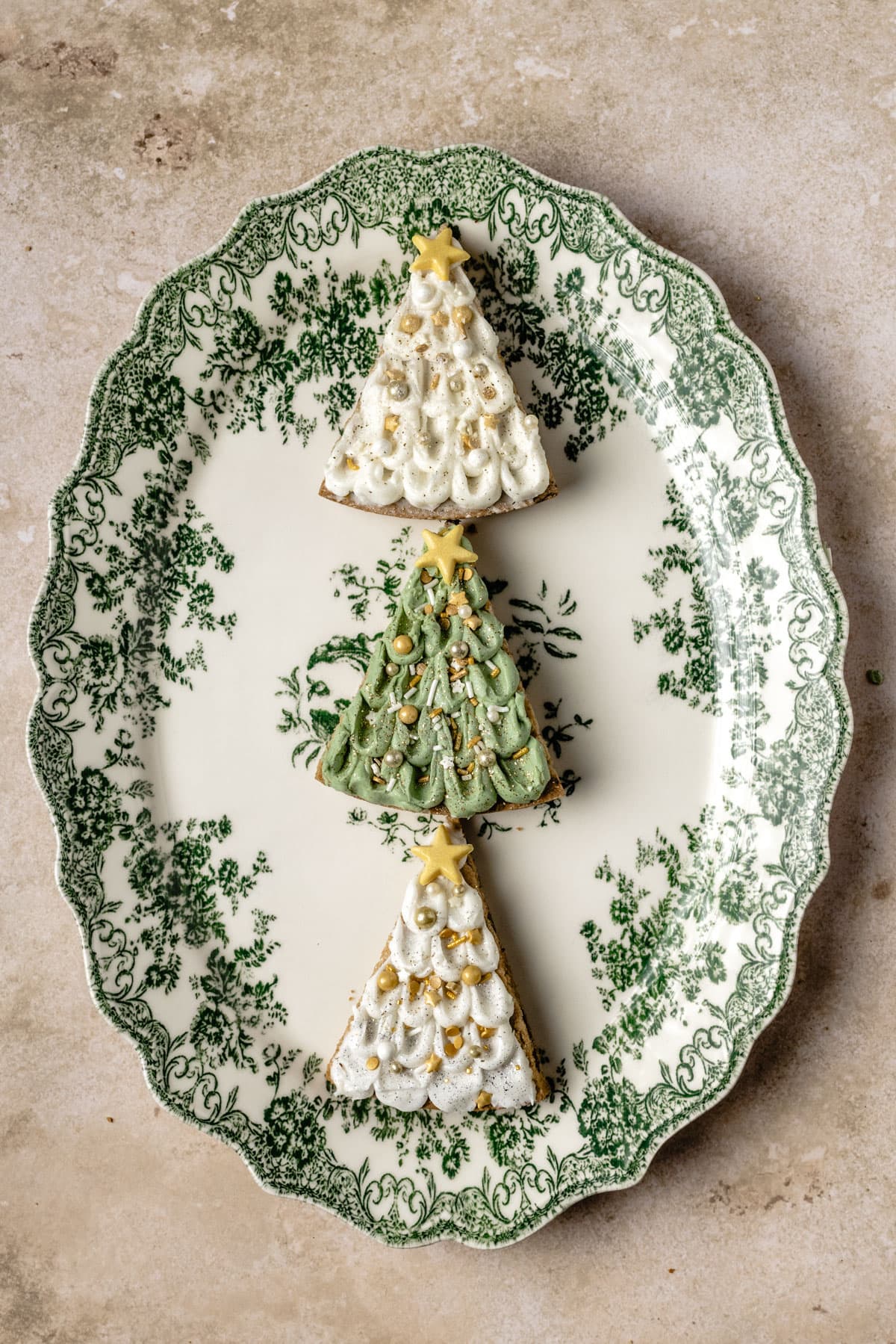 a green platter with three tree cookies in a row. 
