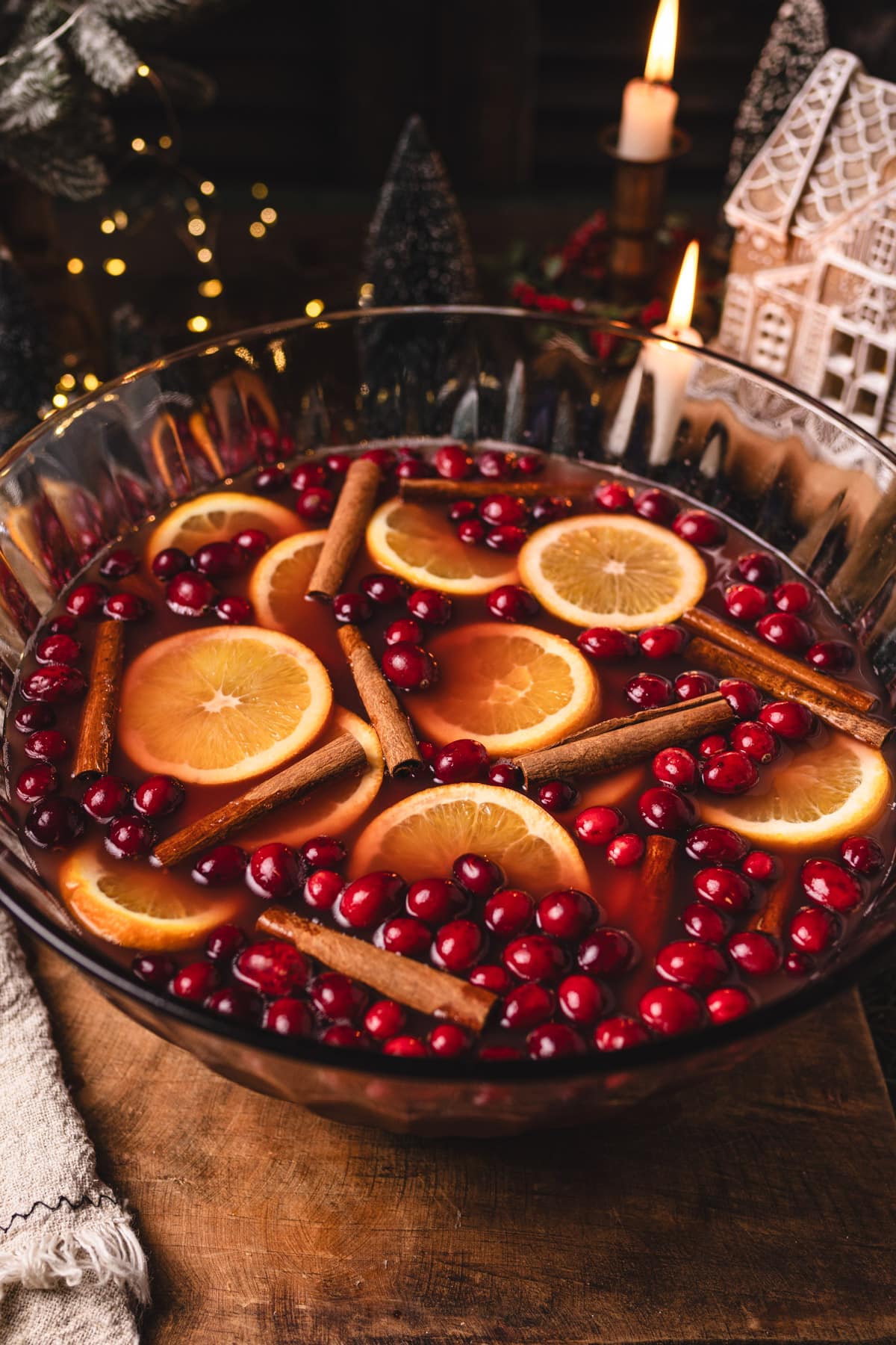 a zoomed out photo showing a large bowl of non-alcoholic christmas punch. 