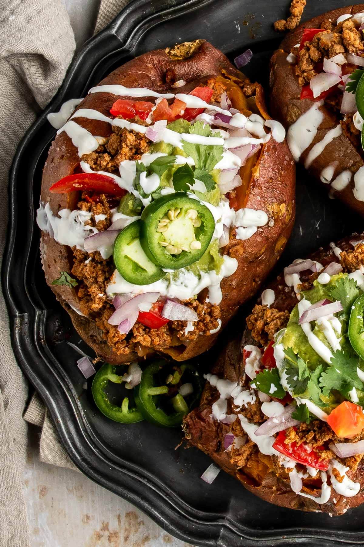 an overhead shot of sweet potatoes stuffed with taco meat and taco toppings