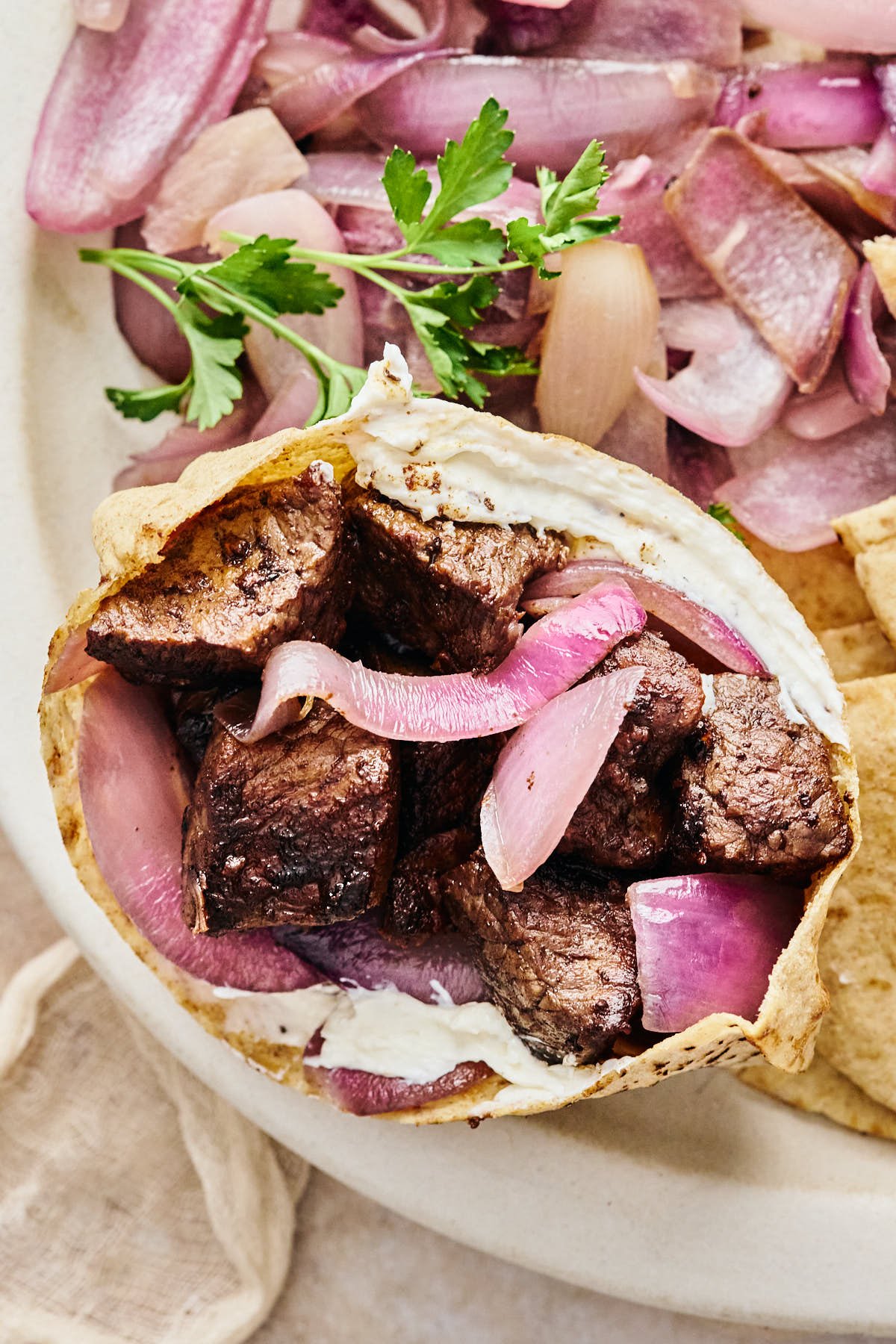 a pita stuffed with sirloin steak bites, grilled onions, and horseradish cream cheese.