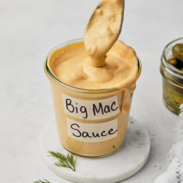 big mac sauce recipe in a jar with a spoon scooping some of the sauce