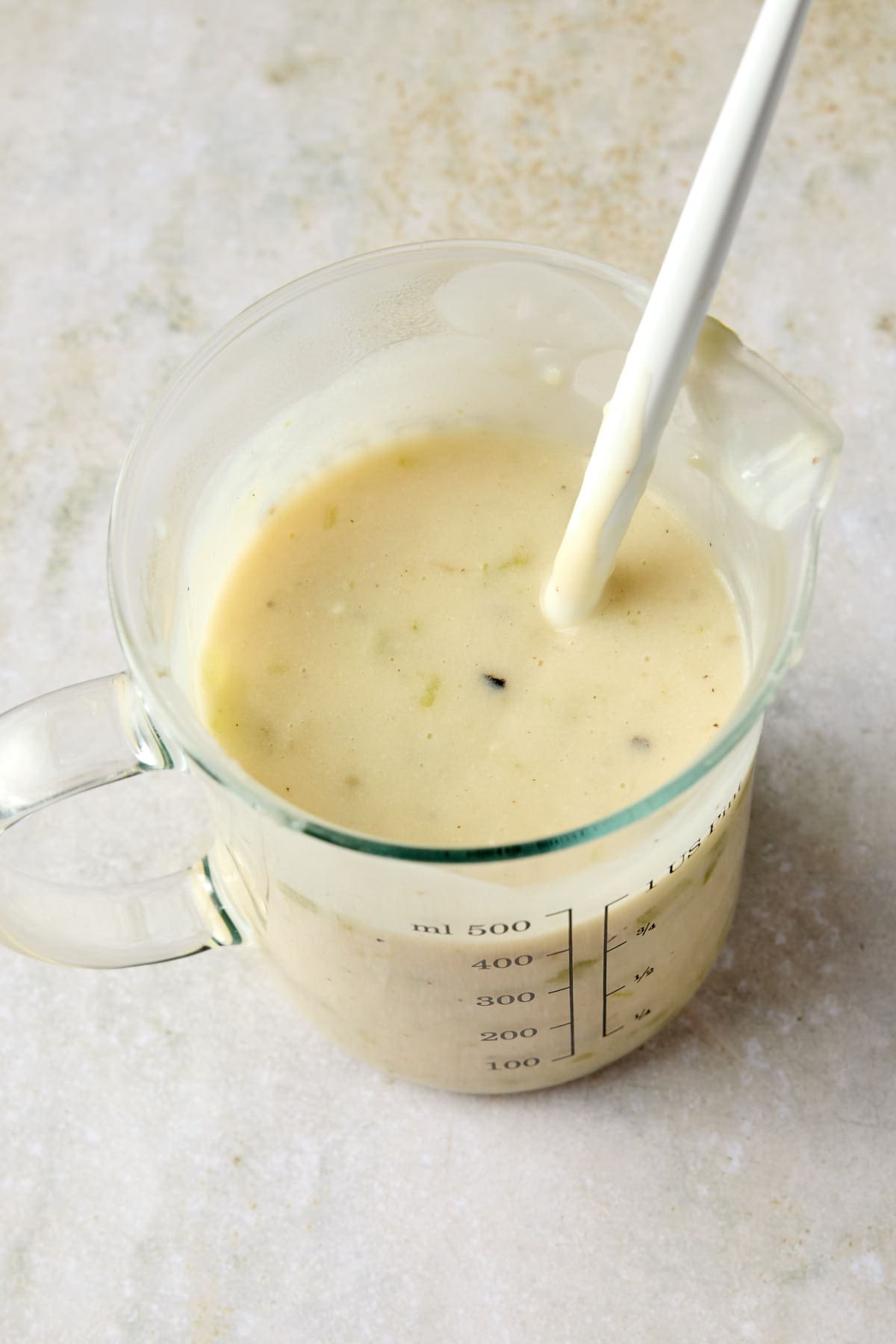 a measuring jar with cream of celery soup substitute inside 