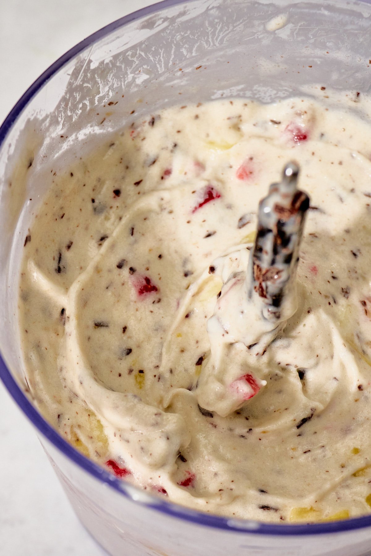 a food processor filled with banana split blizzard ingredients