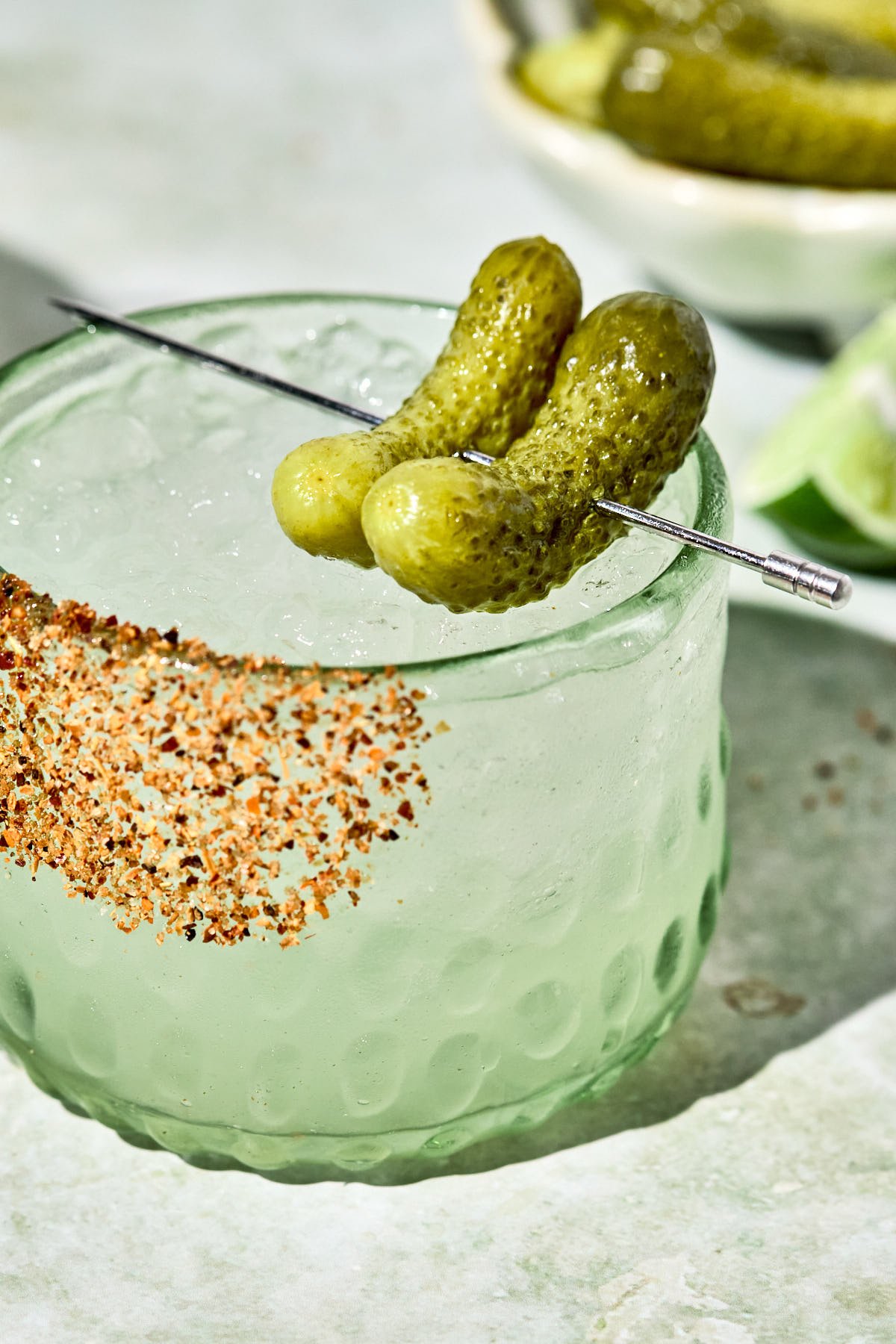 two pickles on top of a pickle margarita