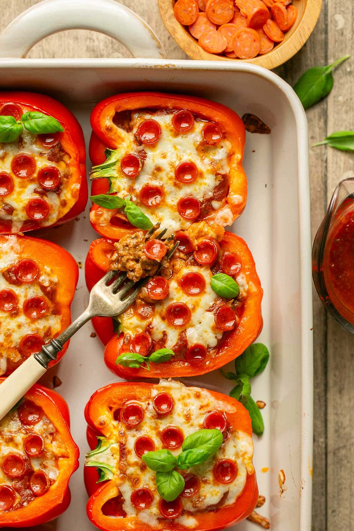 pizza stuffed peppers in a baking dish