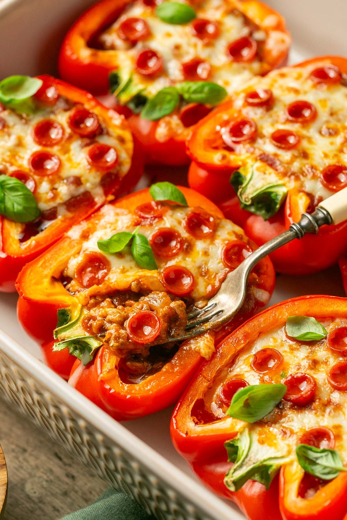pizza stuffed peppers with a fork scooping out the middle