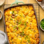 an overhead shot of a tater tot breakfast casserole in a baking dish