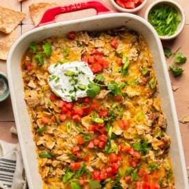 an overhead shot of dorito casserole recipe in a red baking dish