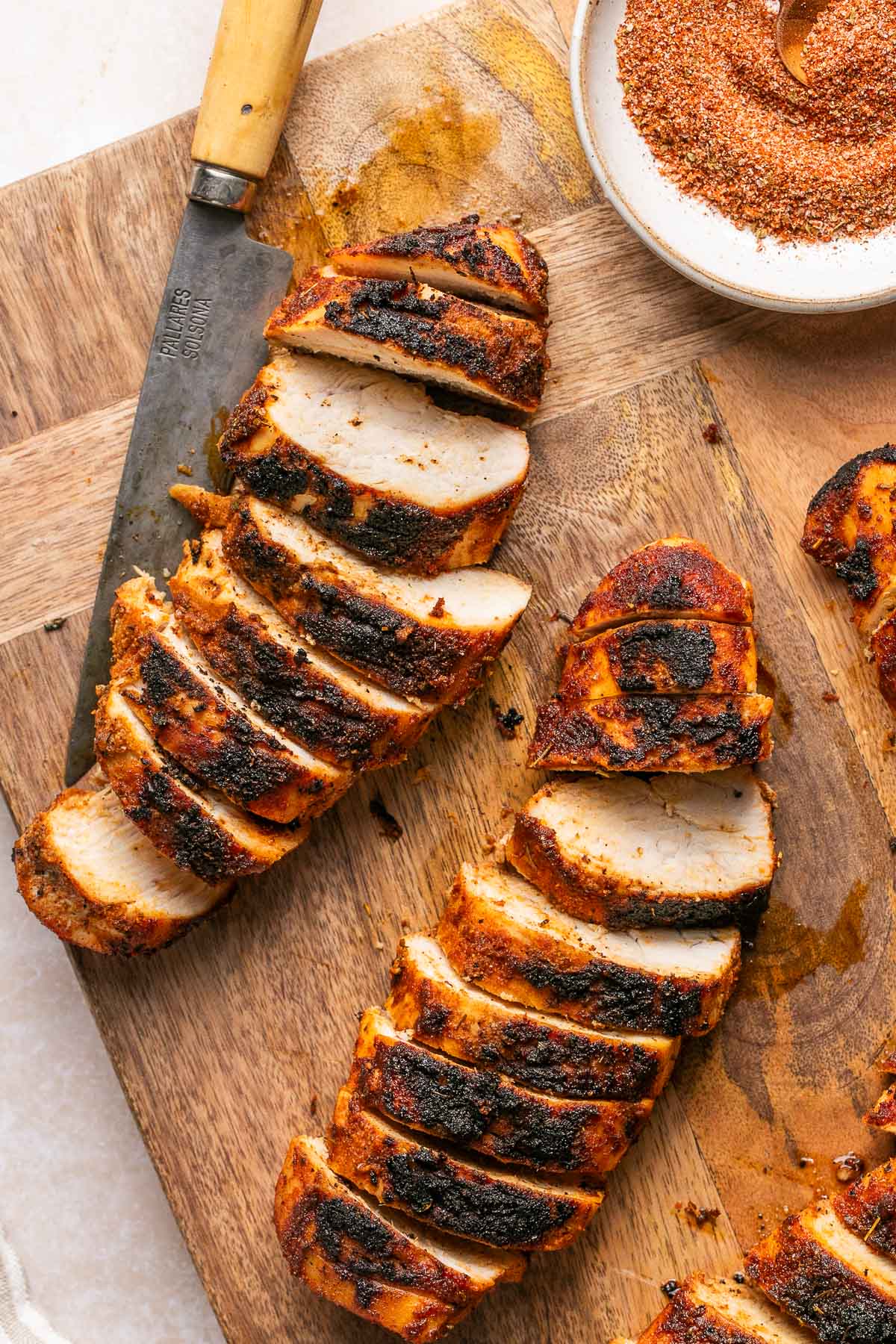 blackened chicken sliced on a cutting board 