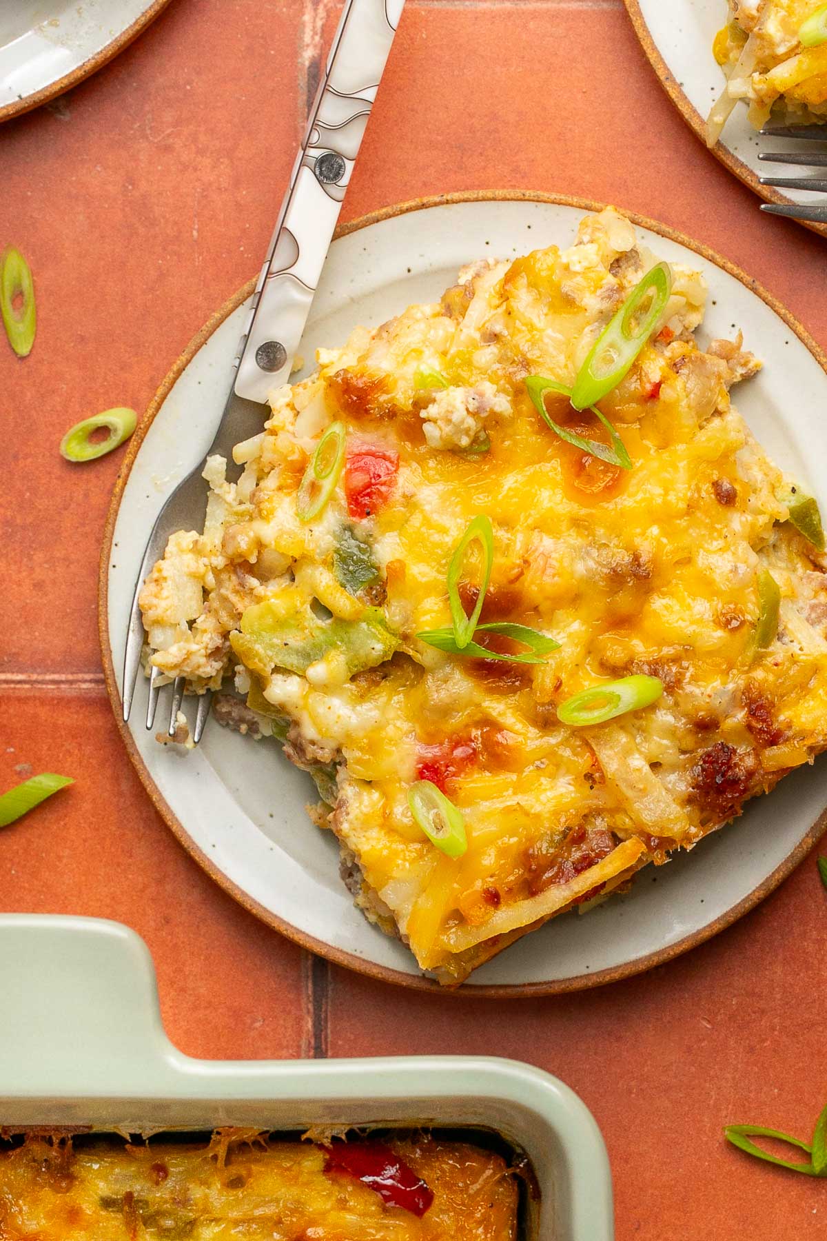 hash brown casserole on a plate with a fork 