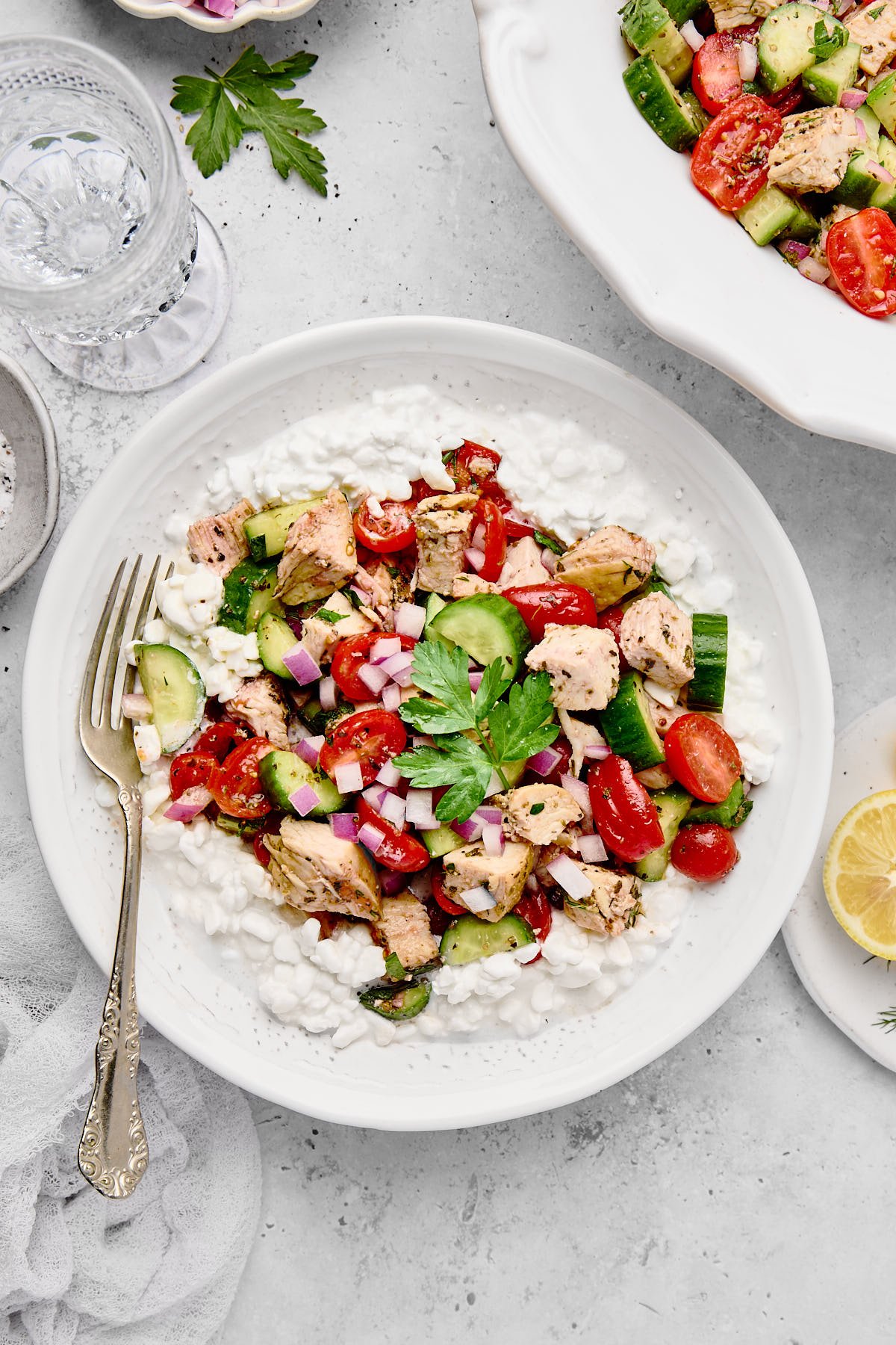 Chicken Cucumber and Tomato Salad over cottage cheese in a bowl