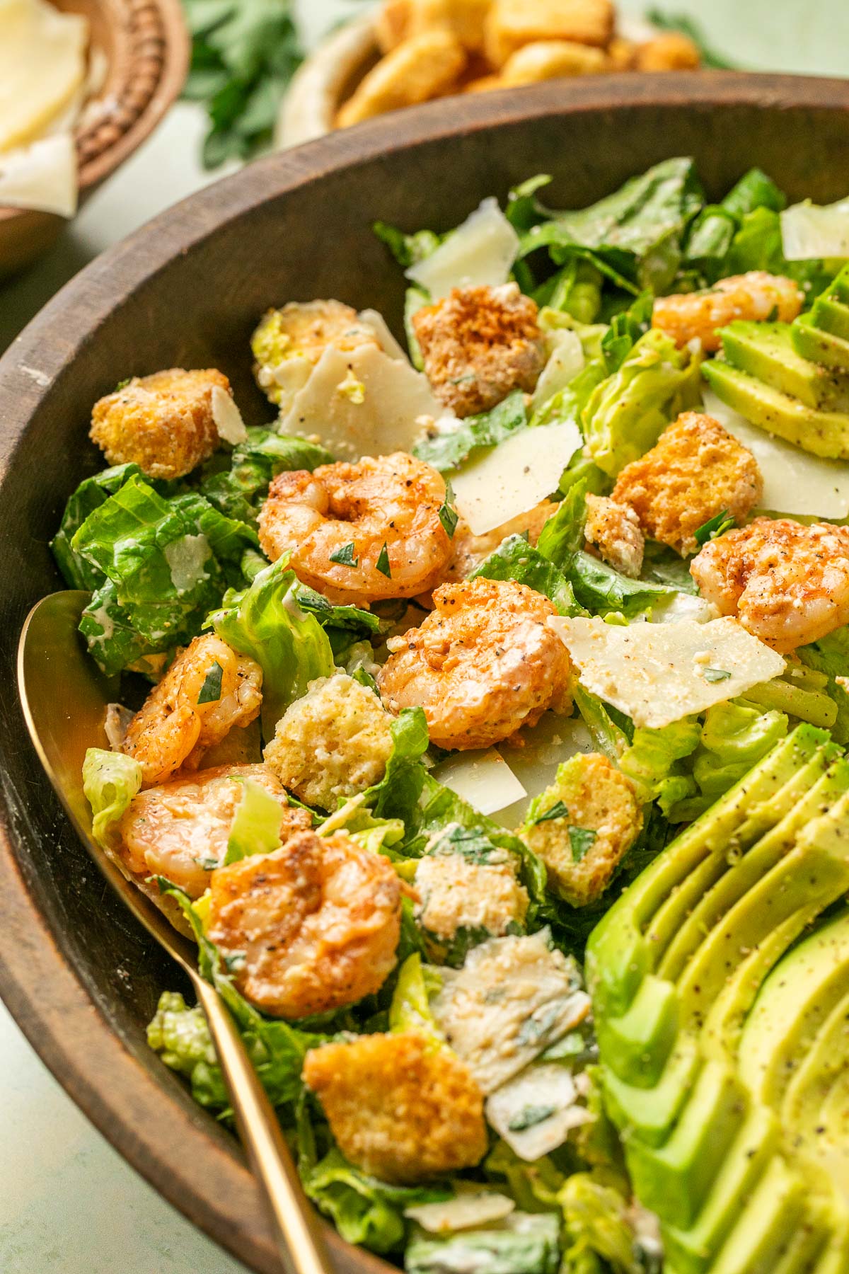 shrimp, parmesan shavings, avocado, and croutons atop a bed of romaine lettuce