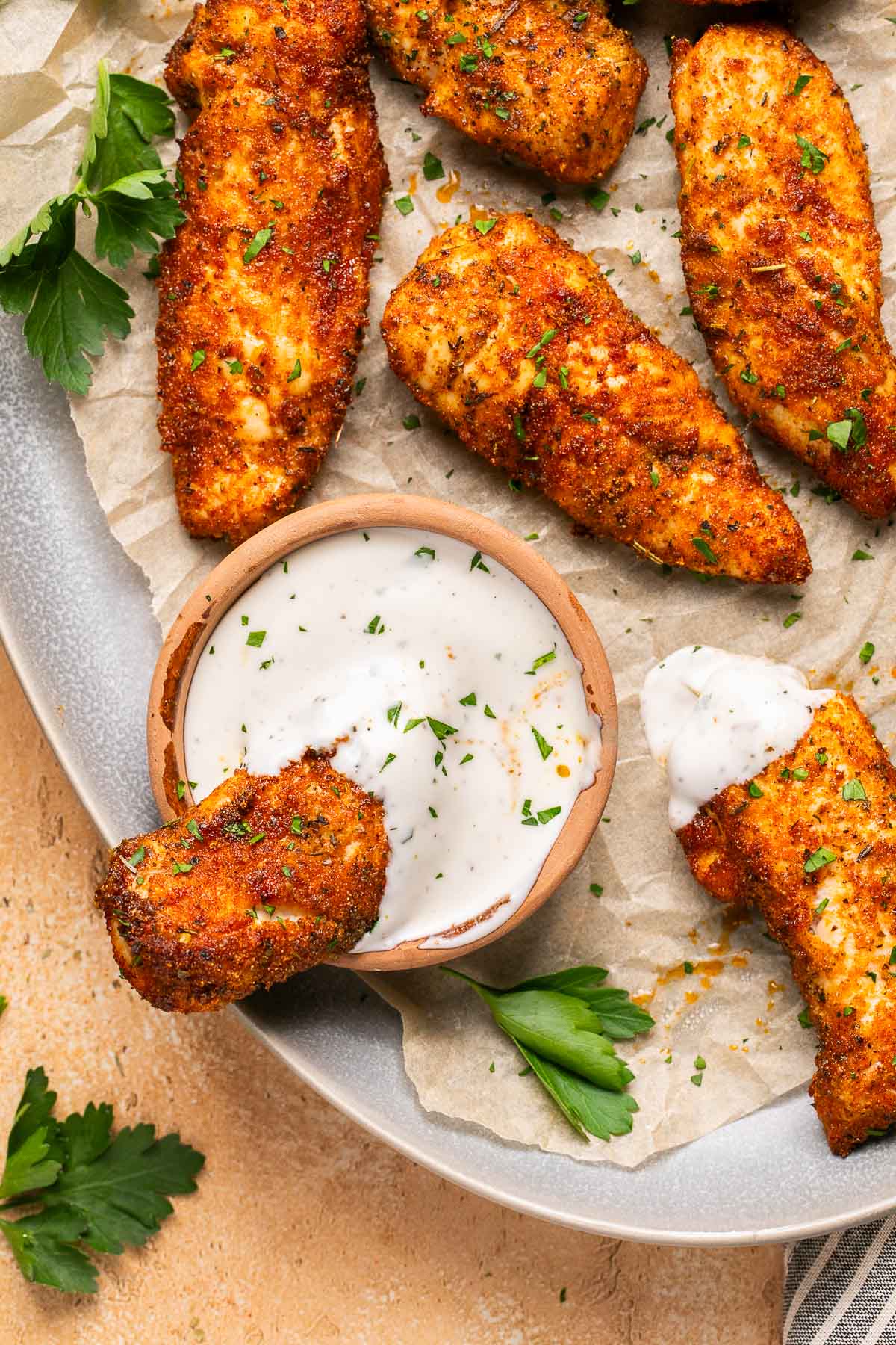 a chicken tender dipped into ranch dressing