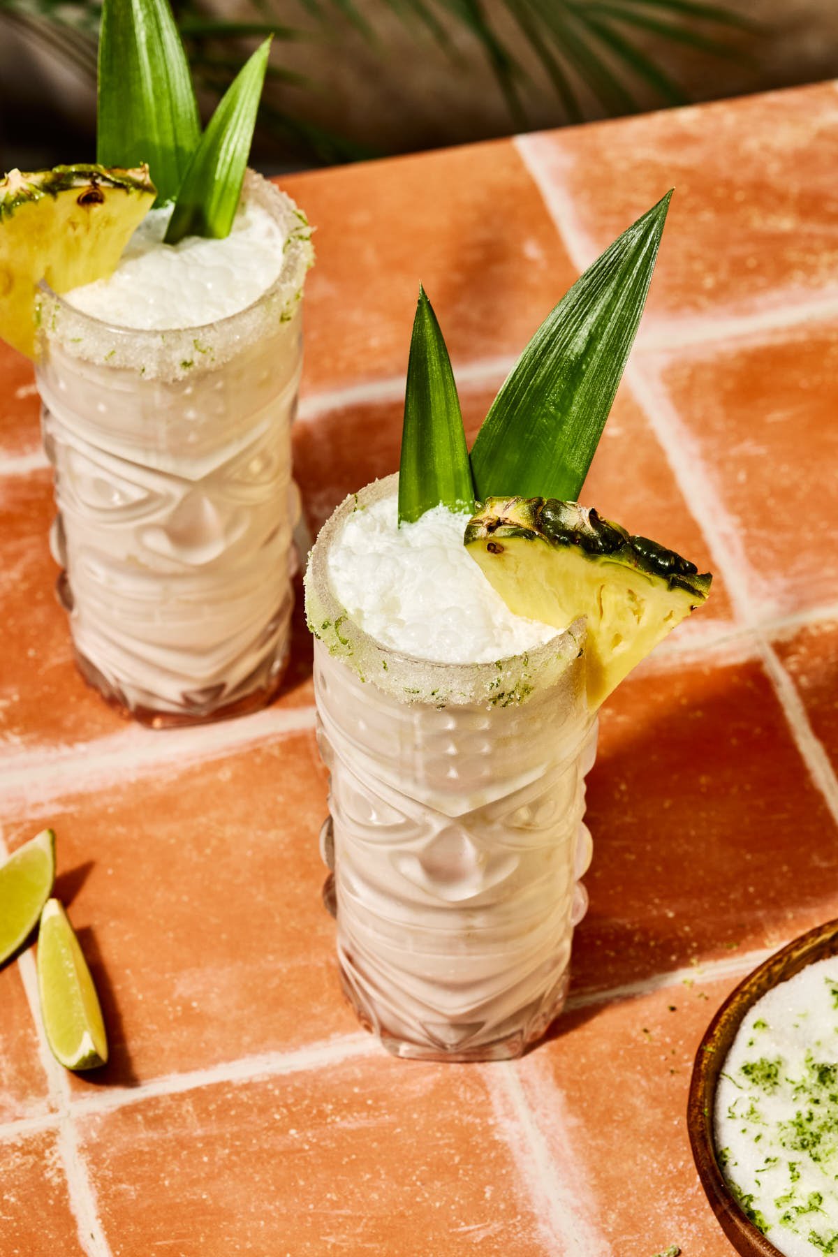 an overhead shot of a coconut mojito recipe in two glasses 