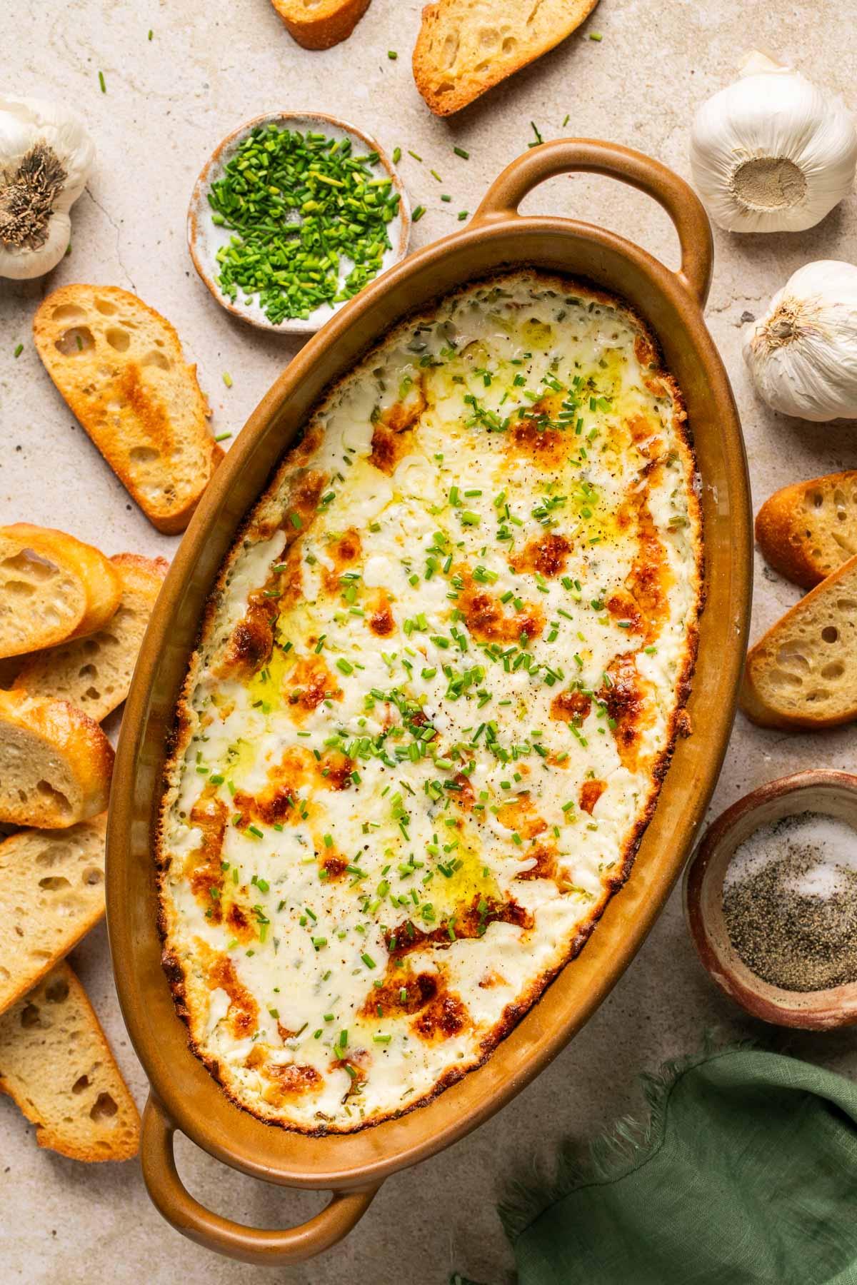 an overhead shot of a baking dish filled with garlic dip