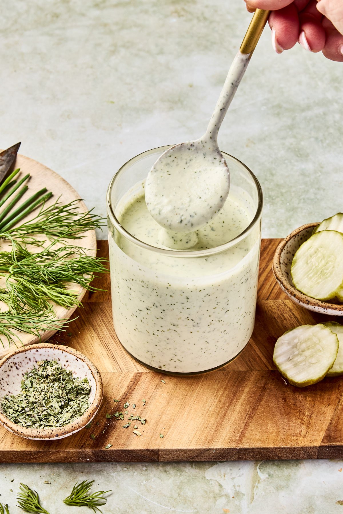 cottage cheese ranch in a jar with a spoon dripping over top