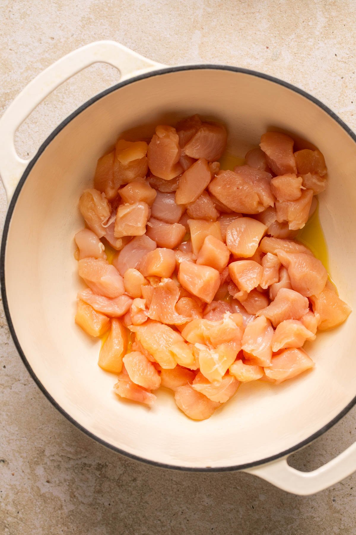 raw chicken in a soup pot