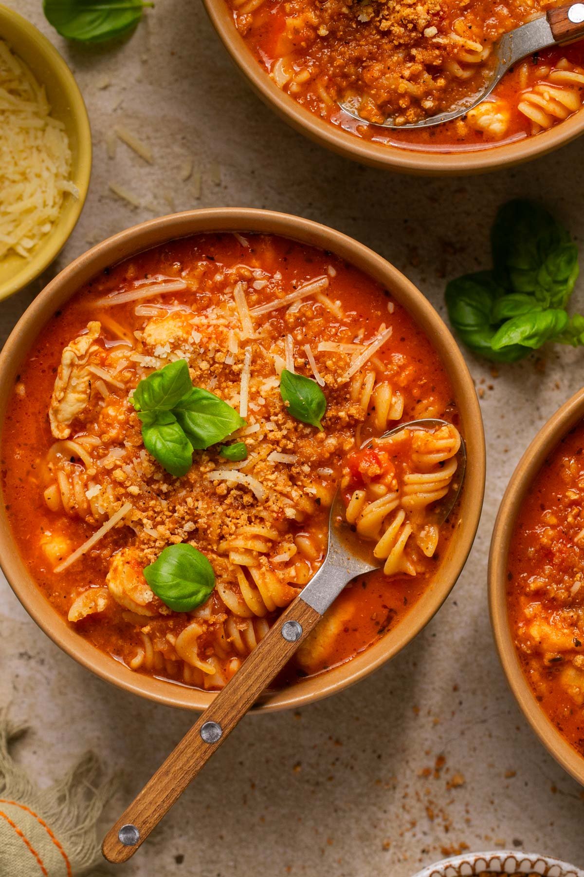 an overhead shot of bowls of chicken parmesan soup 