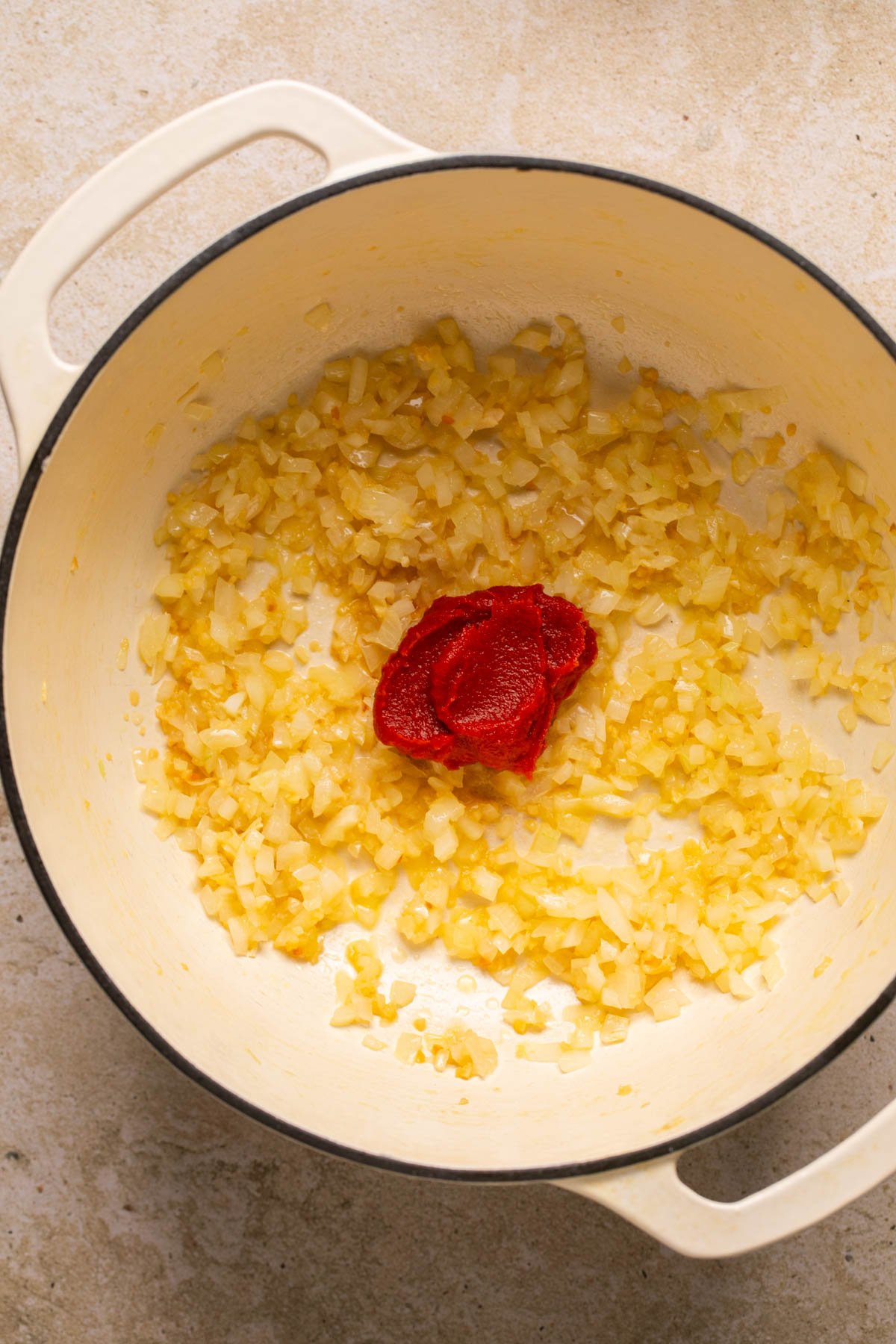 garlic, onions, and tomato paste in a pot