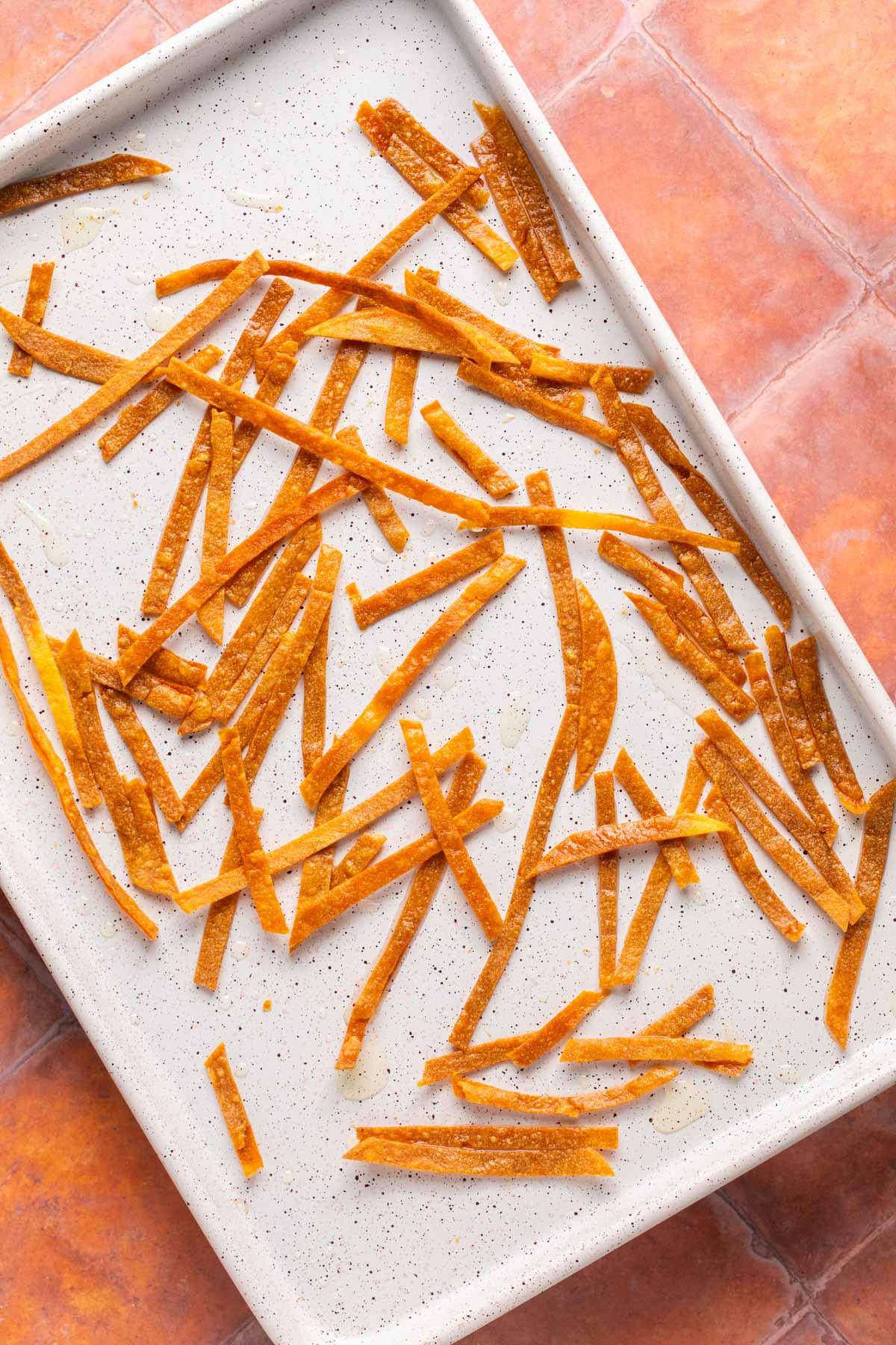 baked tortilla strips on a sheet pan