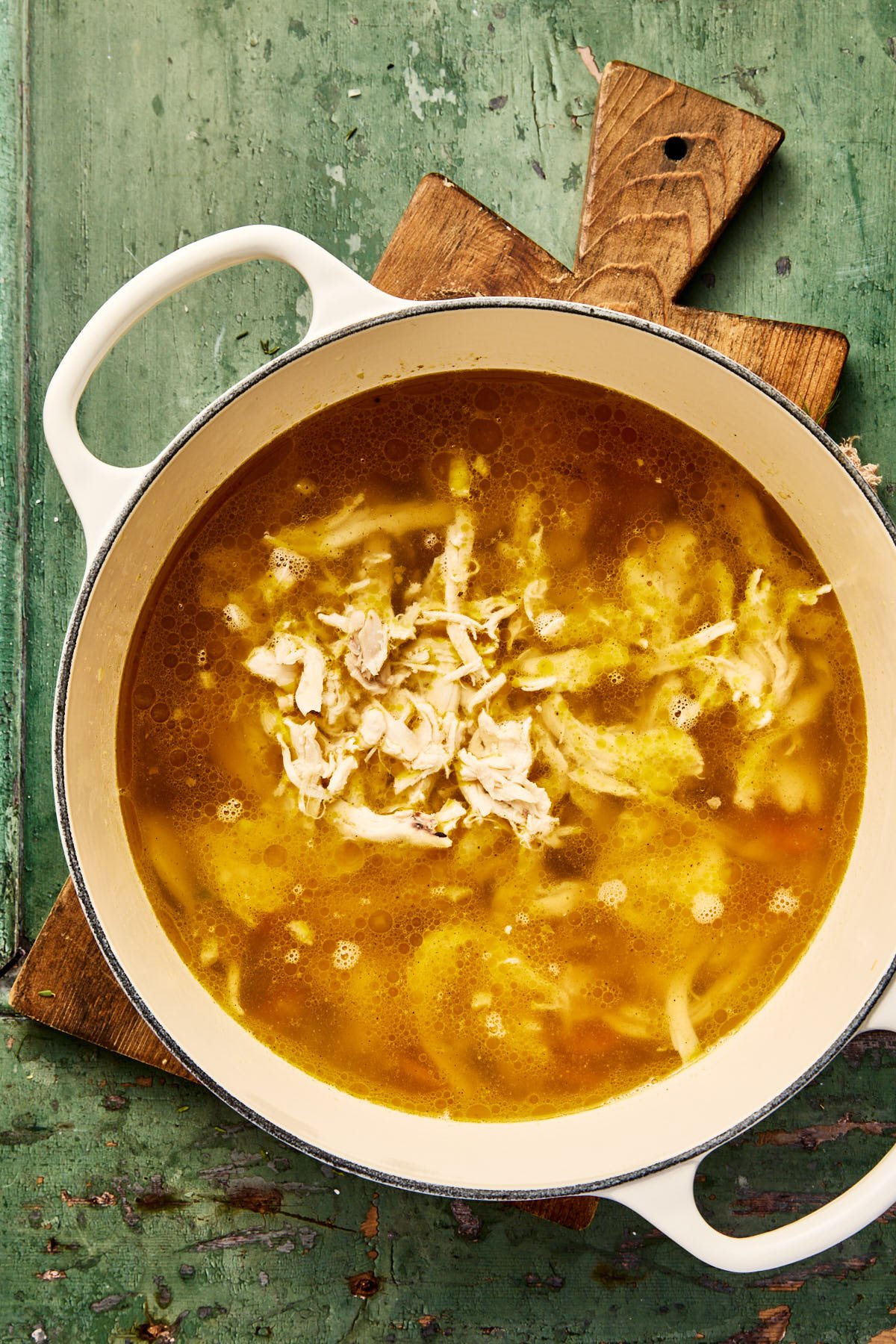 broth and chicken in a soup pot with veggies