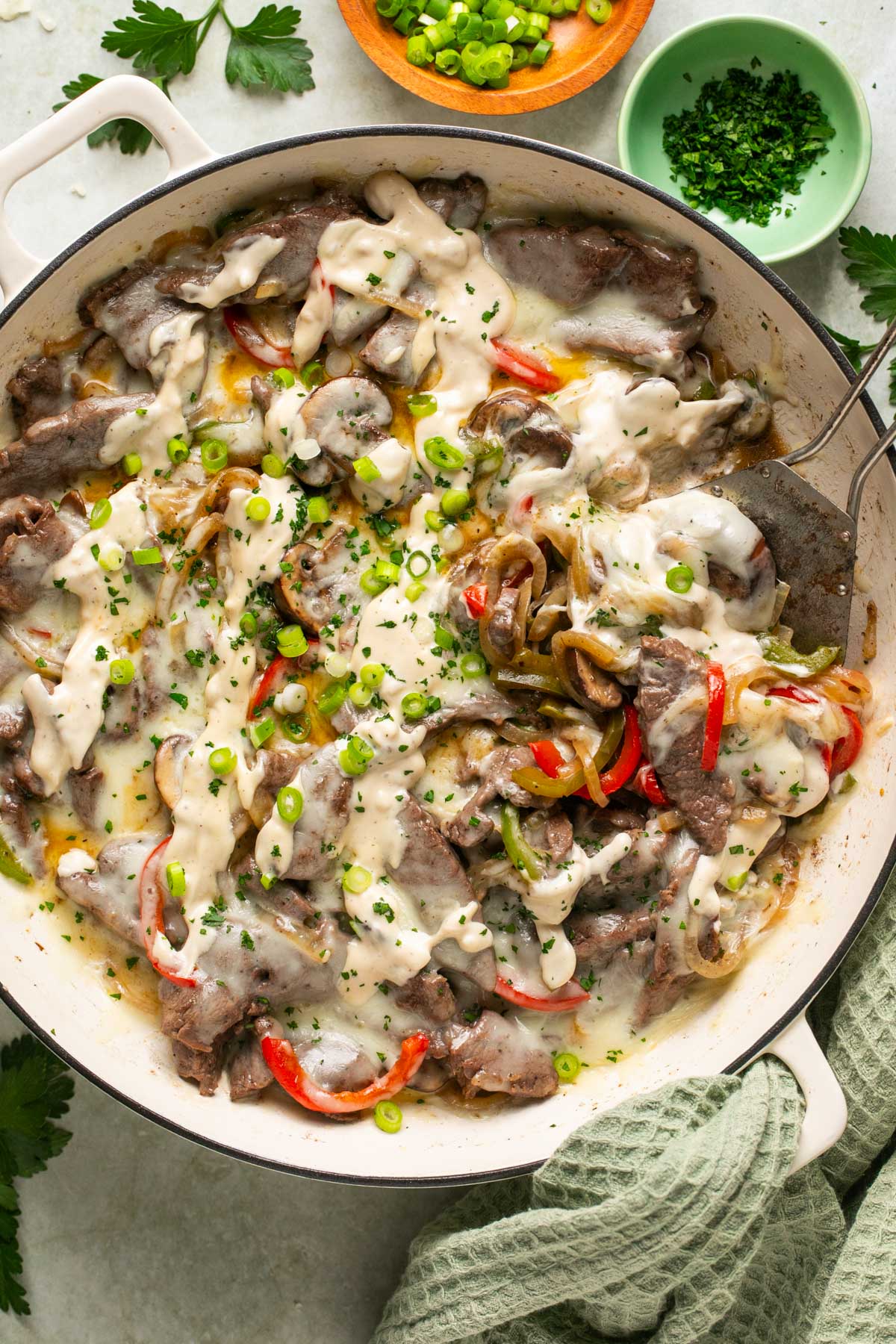 an overhead shot of philly cheesesteak casserole in a skillet 