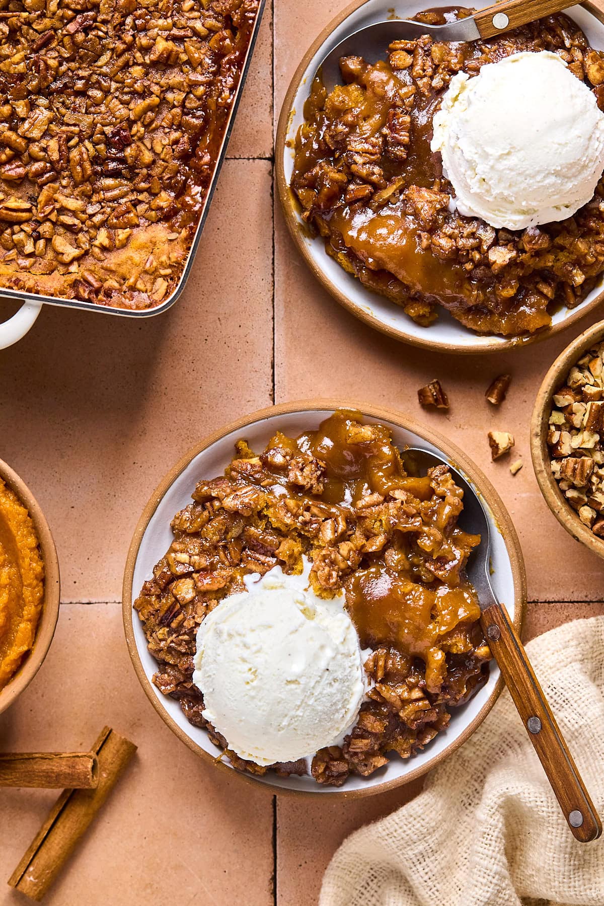 bowl of cobbler portioned out next to the baking dish.