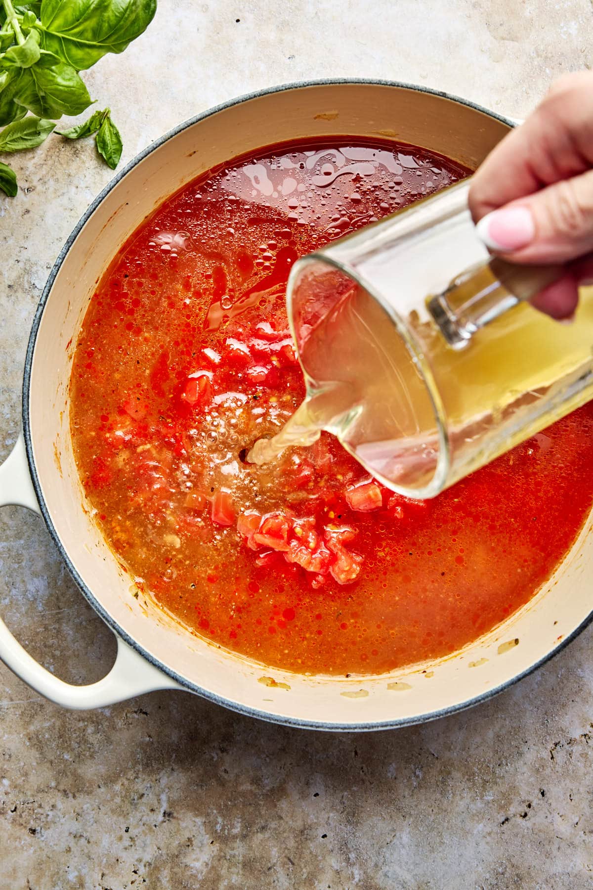 pouring broth into the pot