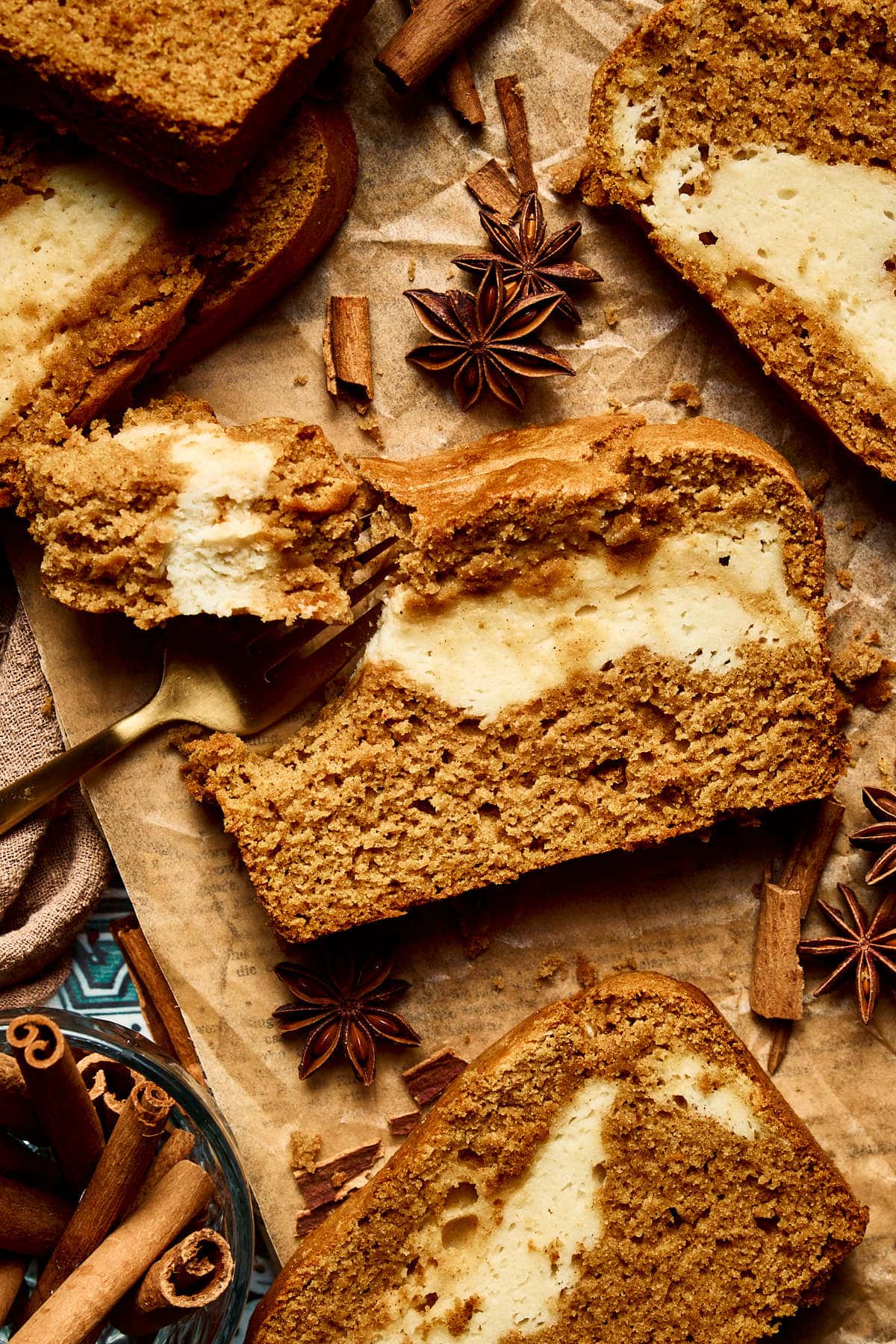 an up close photo of pumpkin cream cheese bread with a bite taken out