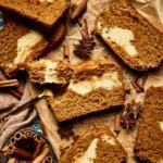 an up close photo of pumpkin cream cheese bread with a bite taken out