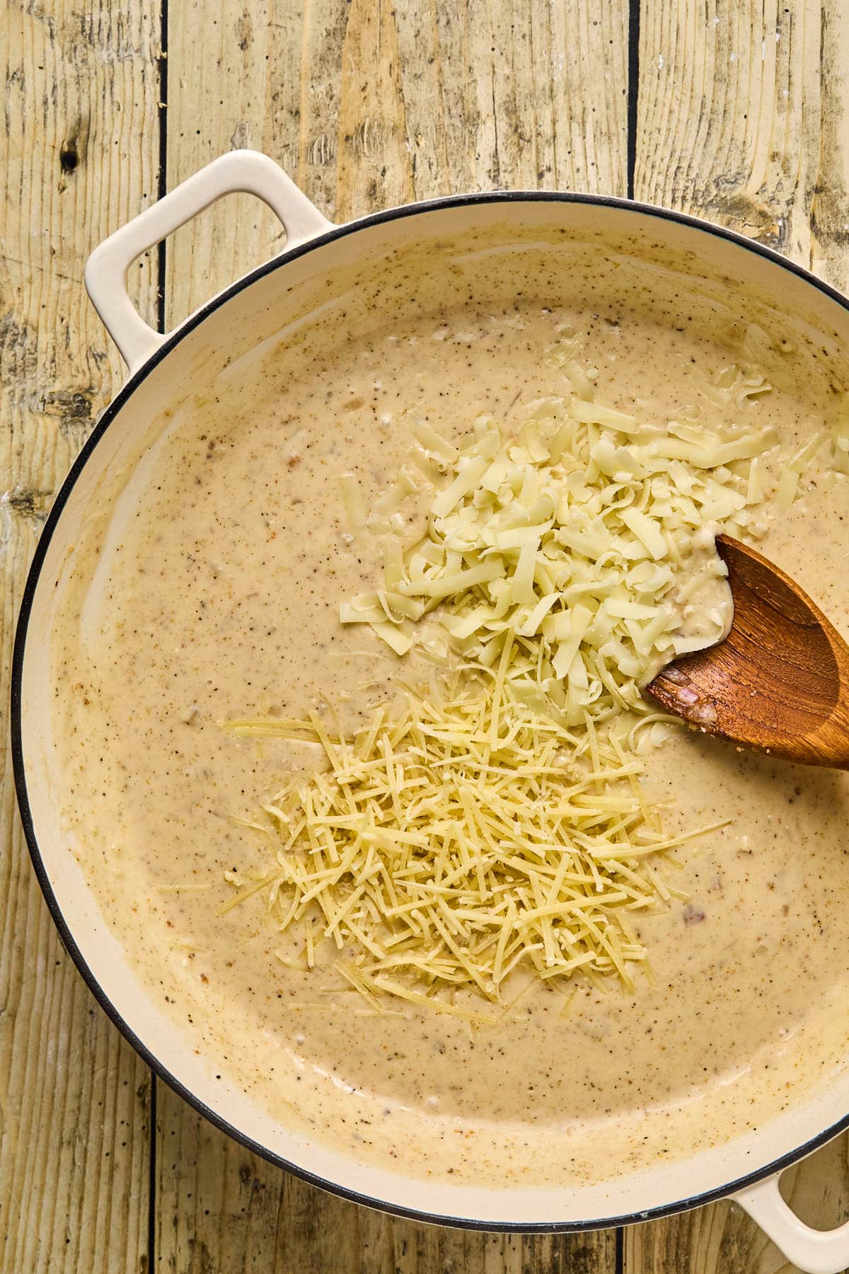 folding in cheese into the skillet