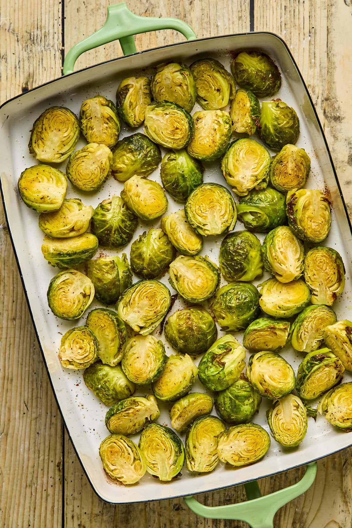 brussels sprouts roasting in a baking dish